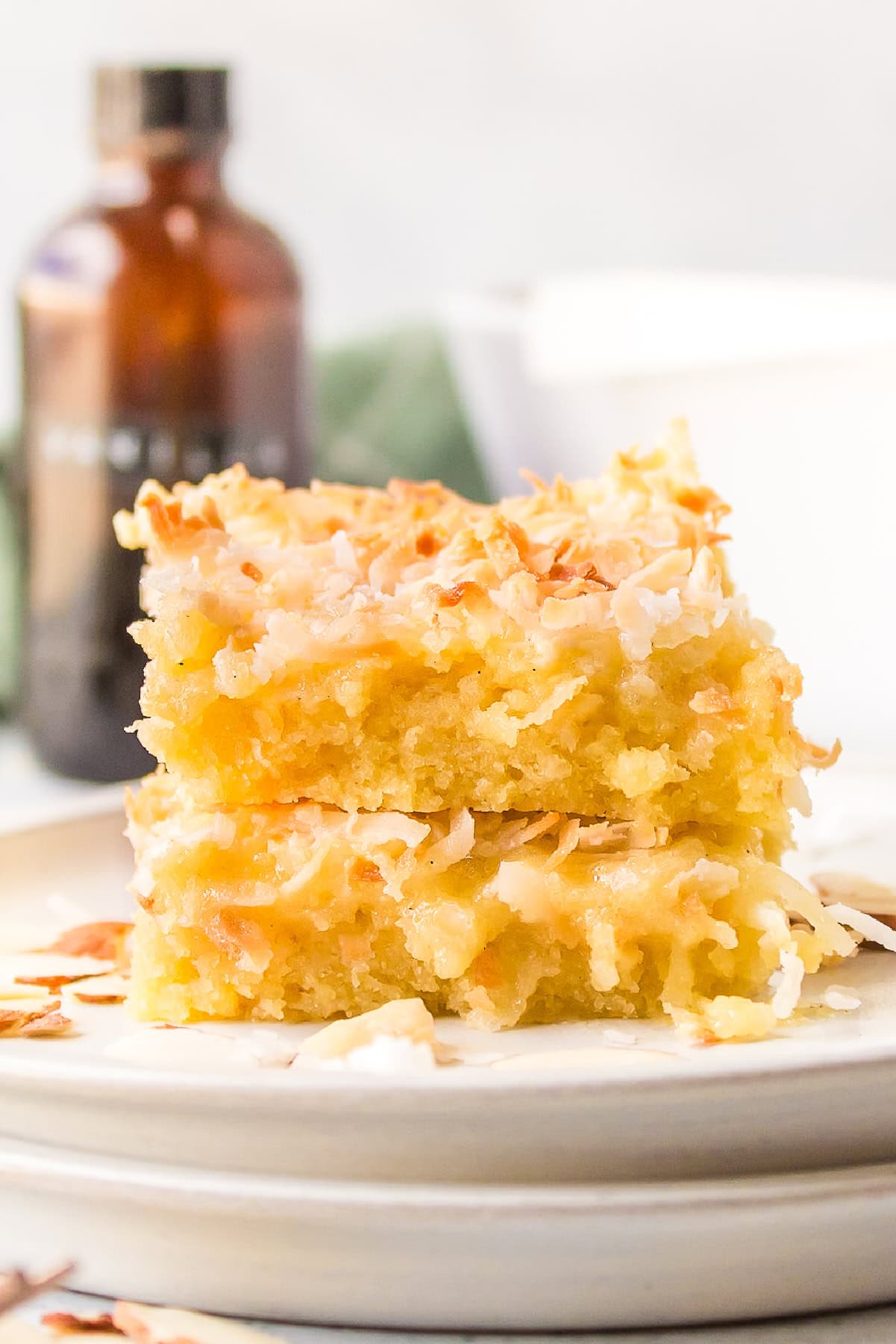 Almond Coconut Bars recipe from RecipeGirl.com two almond coconut bars stacked on plate