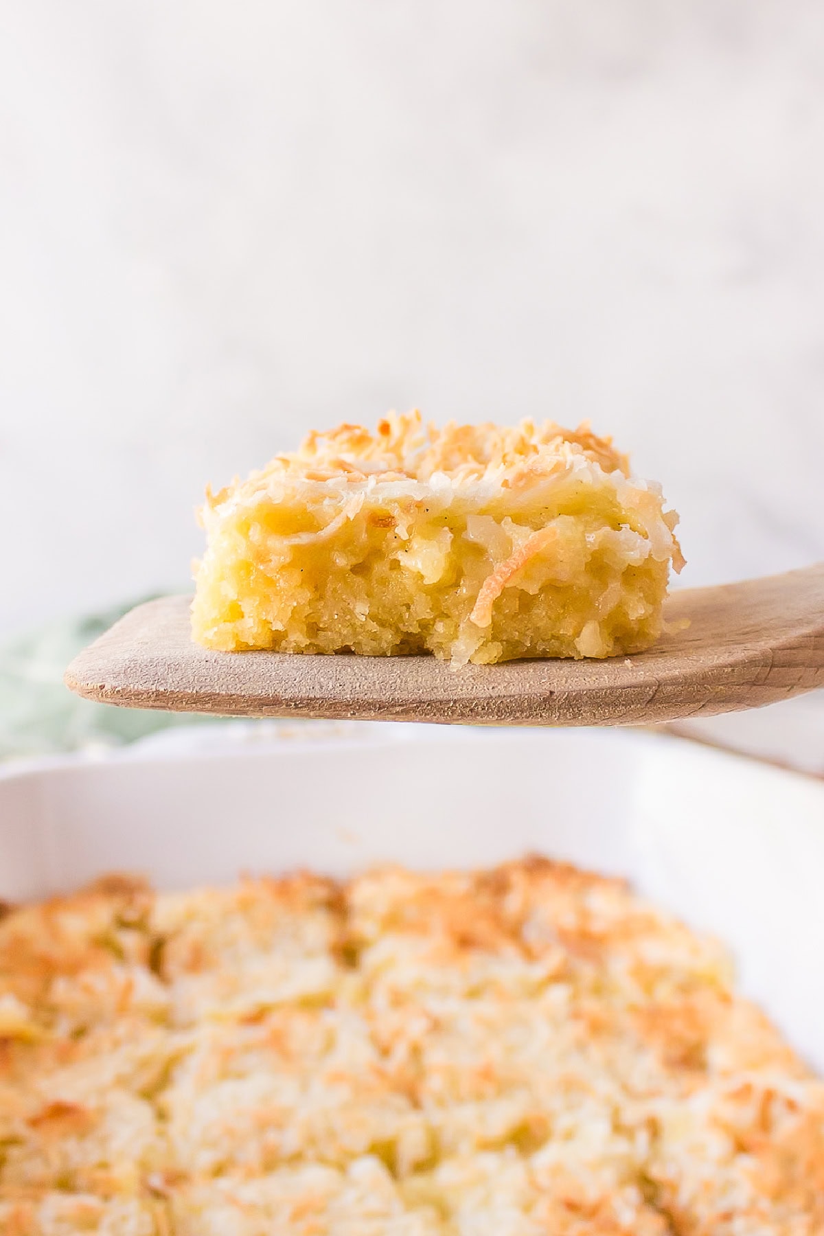 Almond Coconut Bars recipe from RecipeGirl.com spatula holding an almond coconut bar