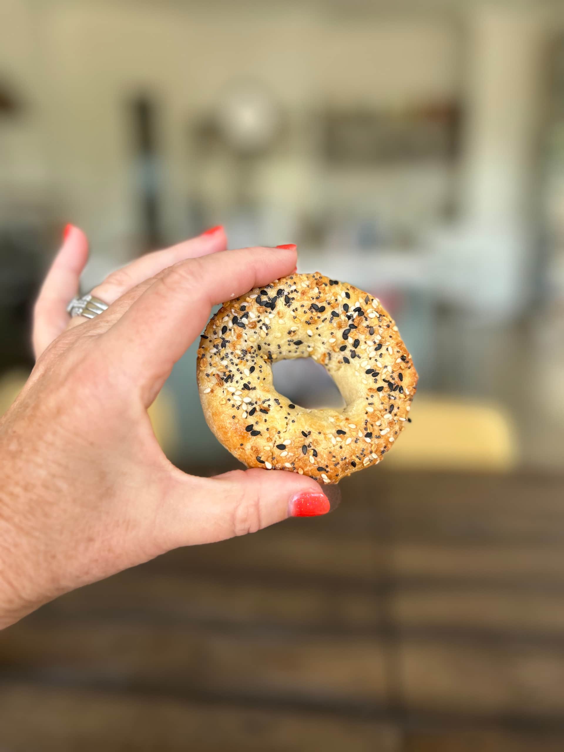 Almond Flour Bagels recipe from RecipeGirl.com hand holding almond flour bagel