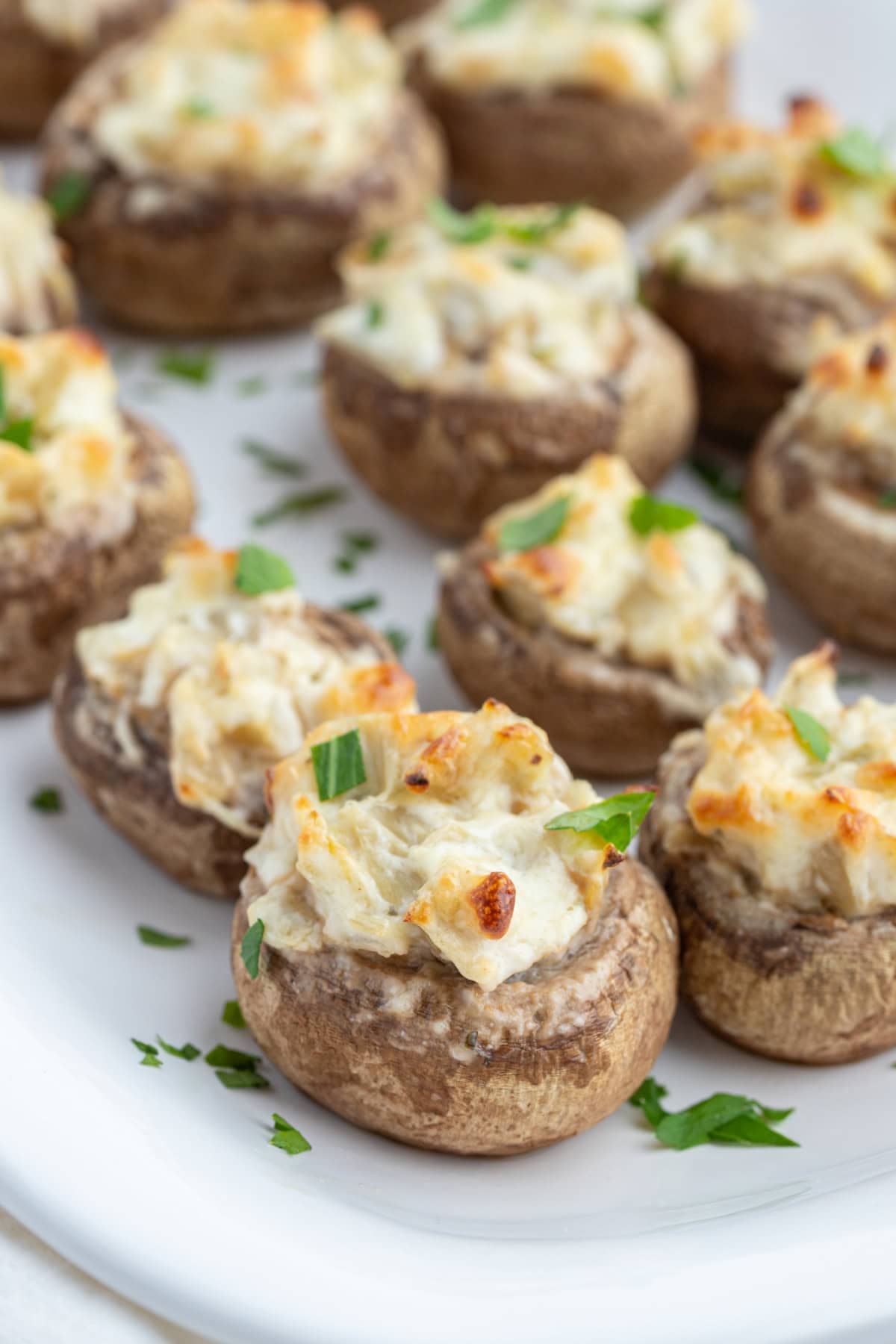 Artichoke Stuffed Mushrooms recipe from RecipeGirl.com artichoke stuffed mushrooms on platter