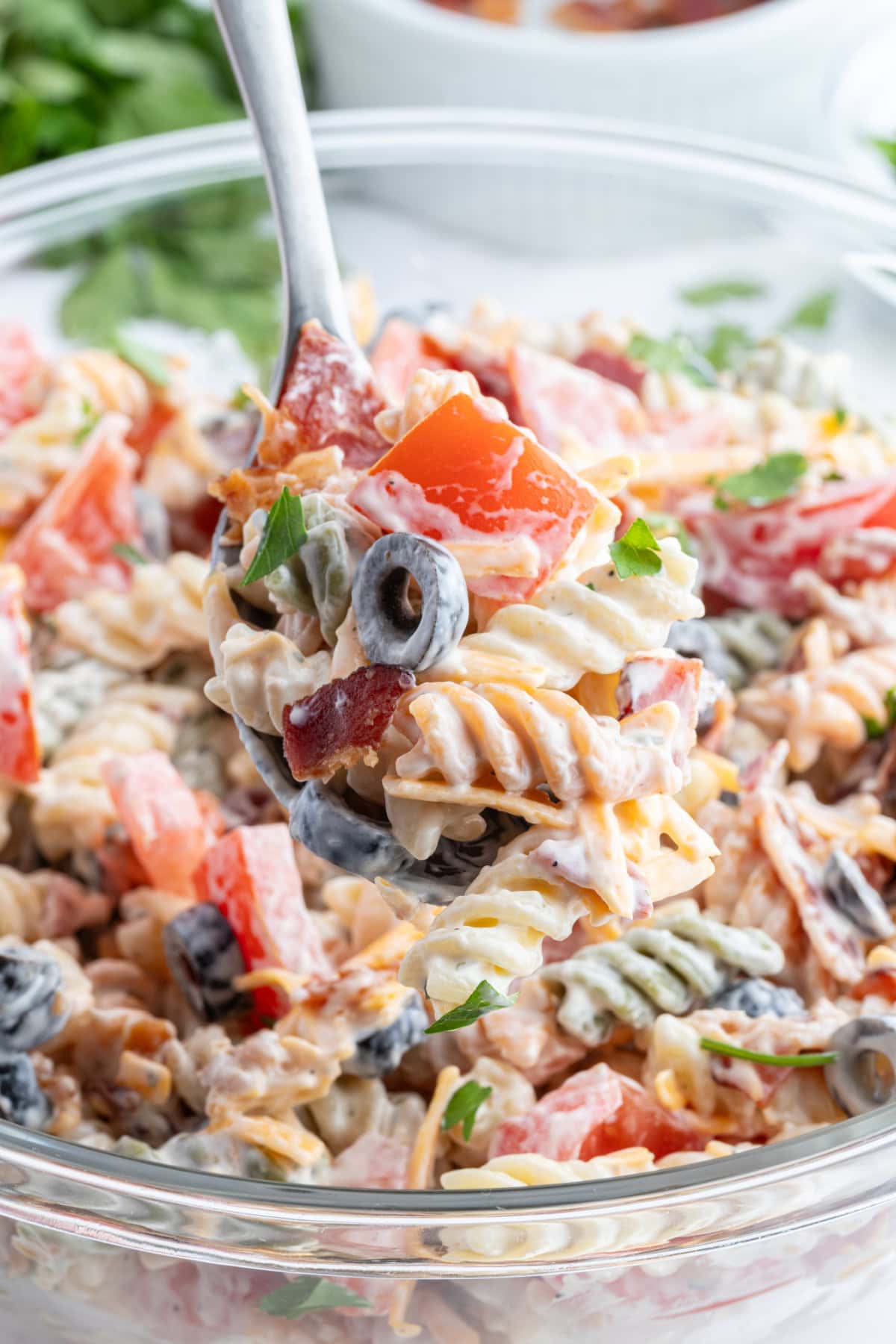 Bacon Ranch Pasta Salad recipe from RecipeGirl.com bacon ranch pasta salad with spoon in bowl