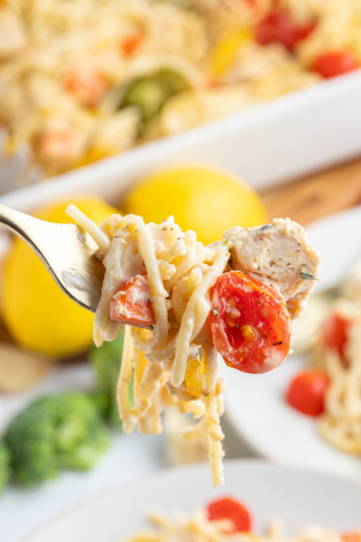 Baked Lemon Chicken Spaghetti Primavera recipe from RecipeGirl.com fork full of baked lemon chicken spaghetti