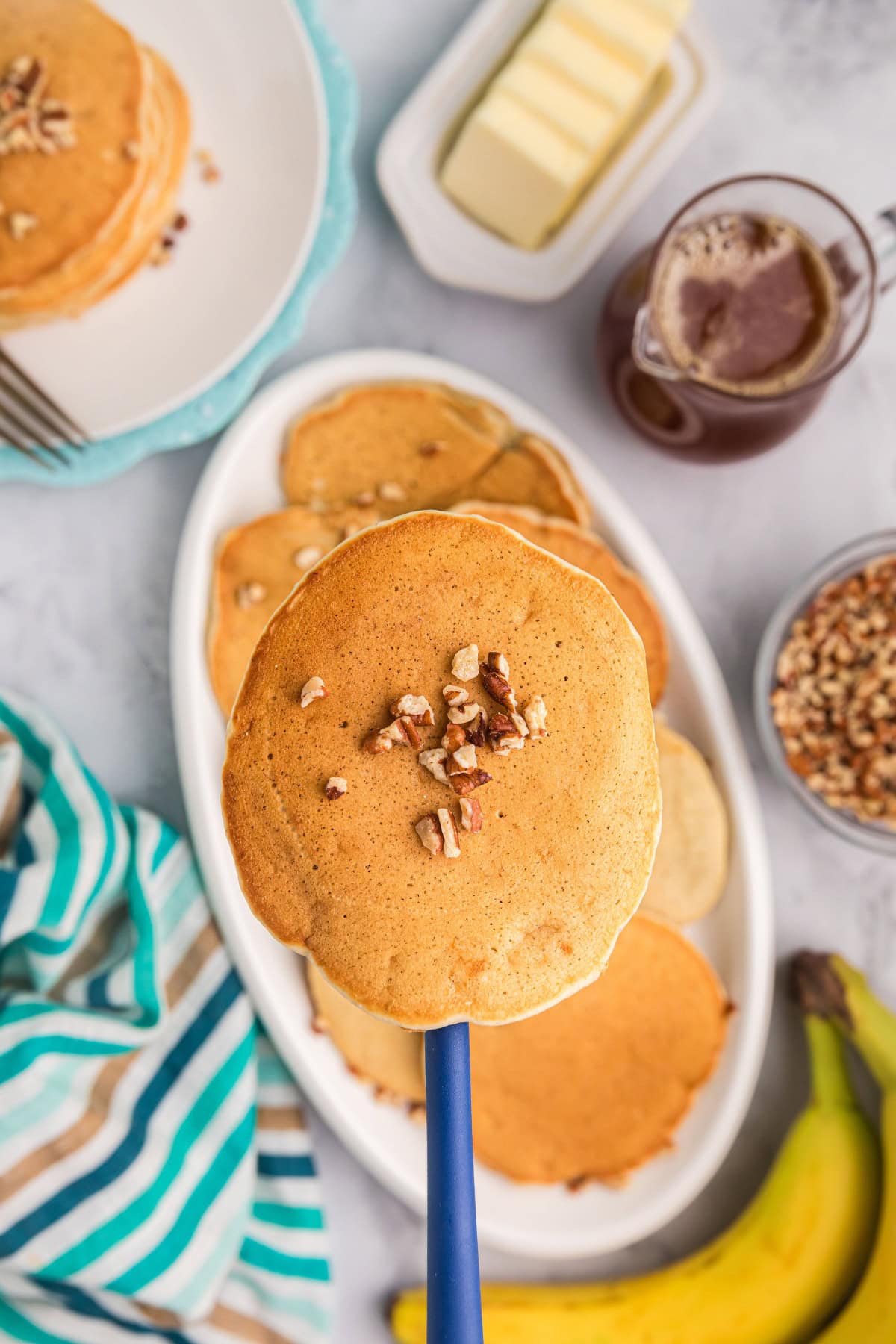 Banana Pecan Pancakes recipe from RecipeGirl.com // easy breakfast and brunch recipe banana pecan pancake on a spatula