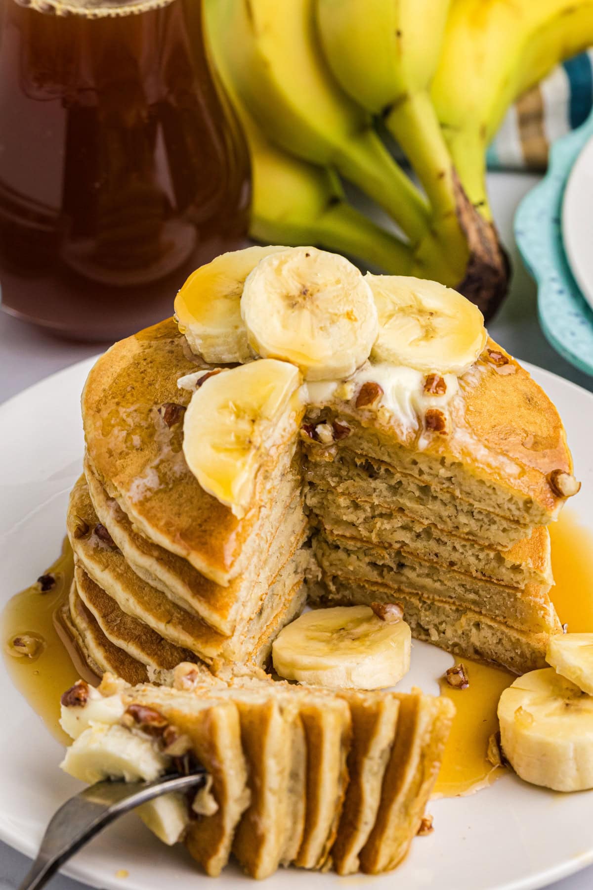 Banana Pecan Pancakes recipe from RecipeGirl.com // easy breakfast and brunch recipe stack of banana pecan pancakes with big slice taken out of them