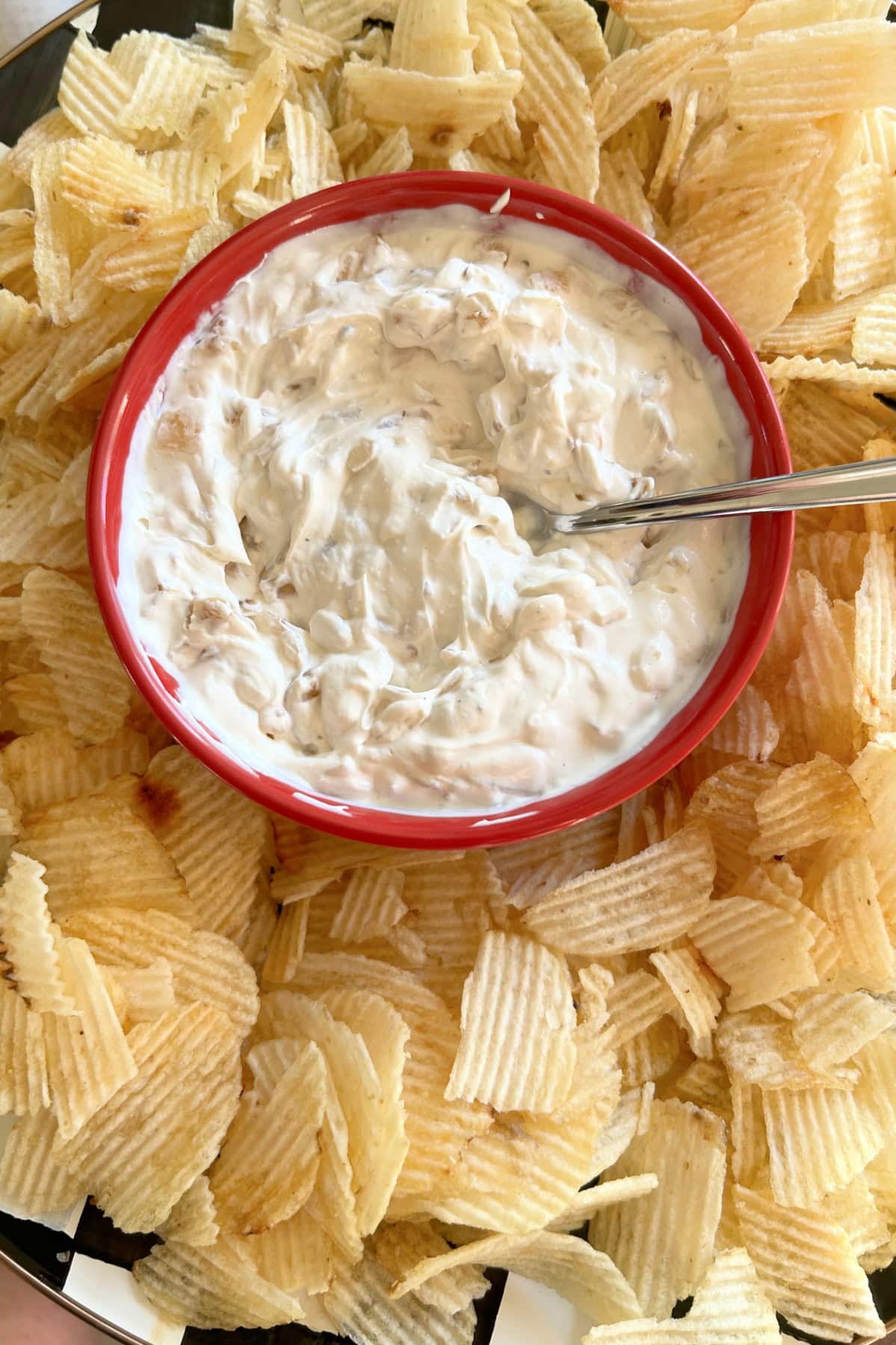 Caramelized Onion Dip recipe from RecipeGirl.com caramelized onion dip in a bowl surrounded by chips