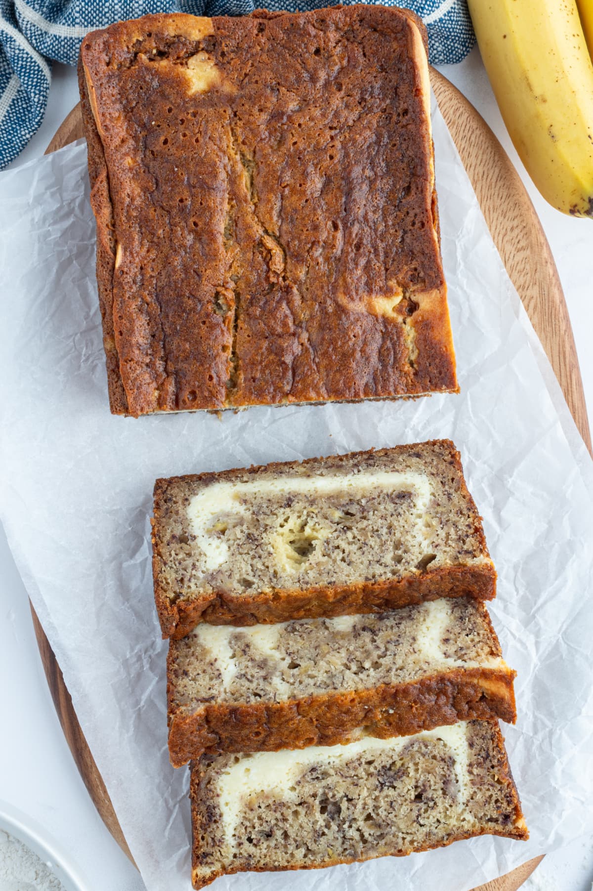 Cheesecake Banana Bread recipe from RecipeGirl.com loaf of cheesecake banana bread with some sliced