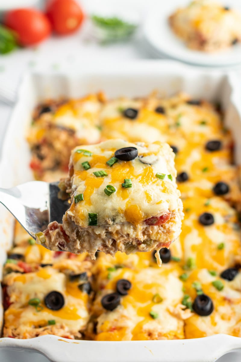 Chicken Enchilada Casserole recipe from RecipeGirl.com #chicken #enchilada #casserole #recipe #RecipeGirl spatula serving enchilada casserole