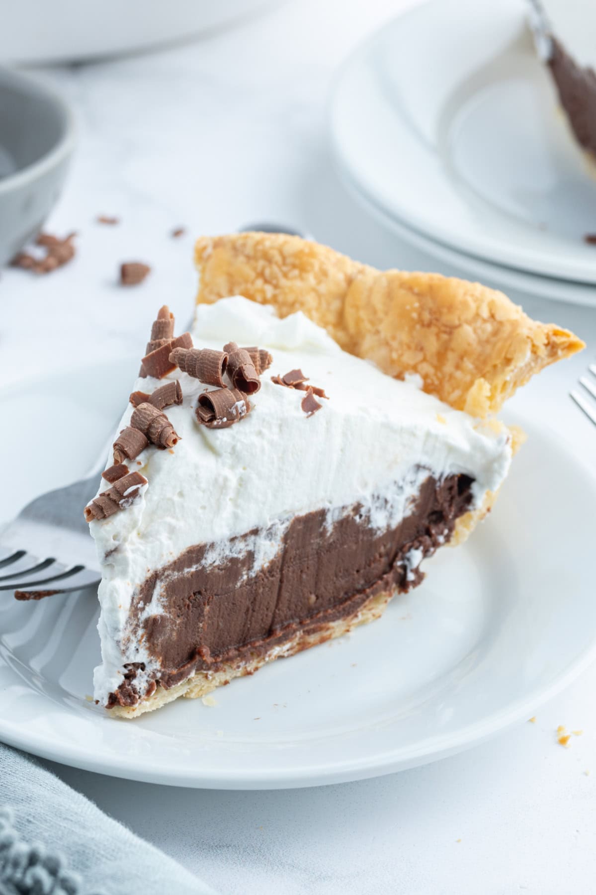 Totally delicious classic easy Chocolate Cream Pie recipe from RecipeGirl.com slice of chocolate cream pie on a plate