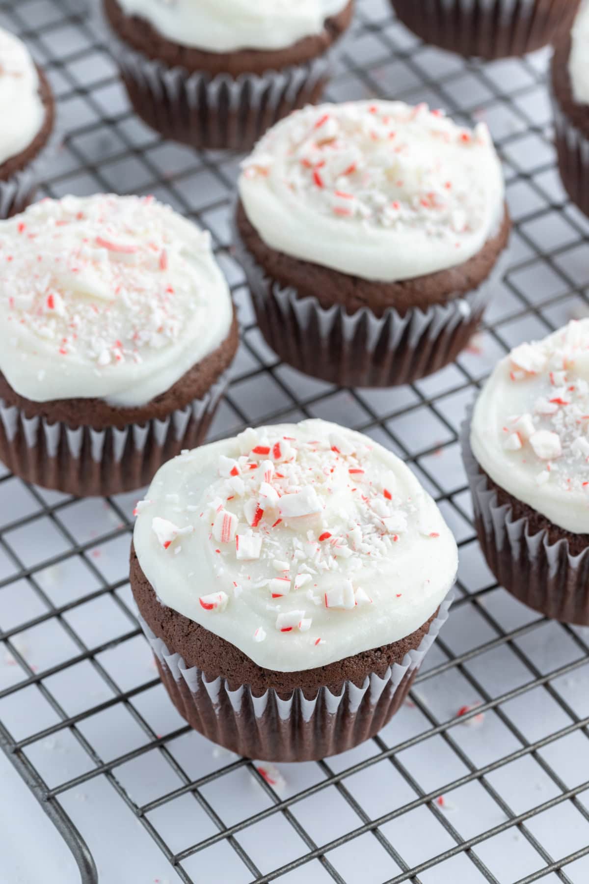 Chocolate Cupcakes with Peppermint Icing recipe from RecipeGirl.com chocolate cupcakes with peppermint icing on cooling rack