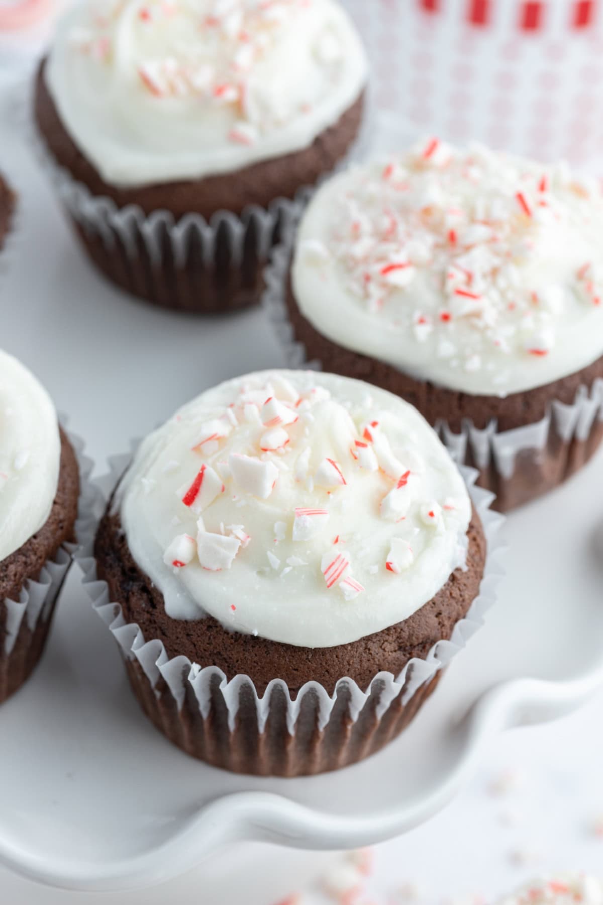 Chocolate Cupcakes with Peppermint Icing recipe from RecipeGirl.com chocolate cupcakes with peppermint icing on display stand
