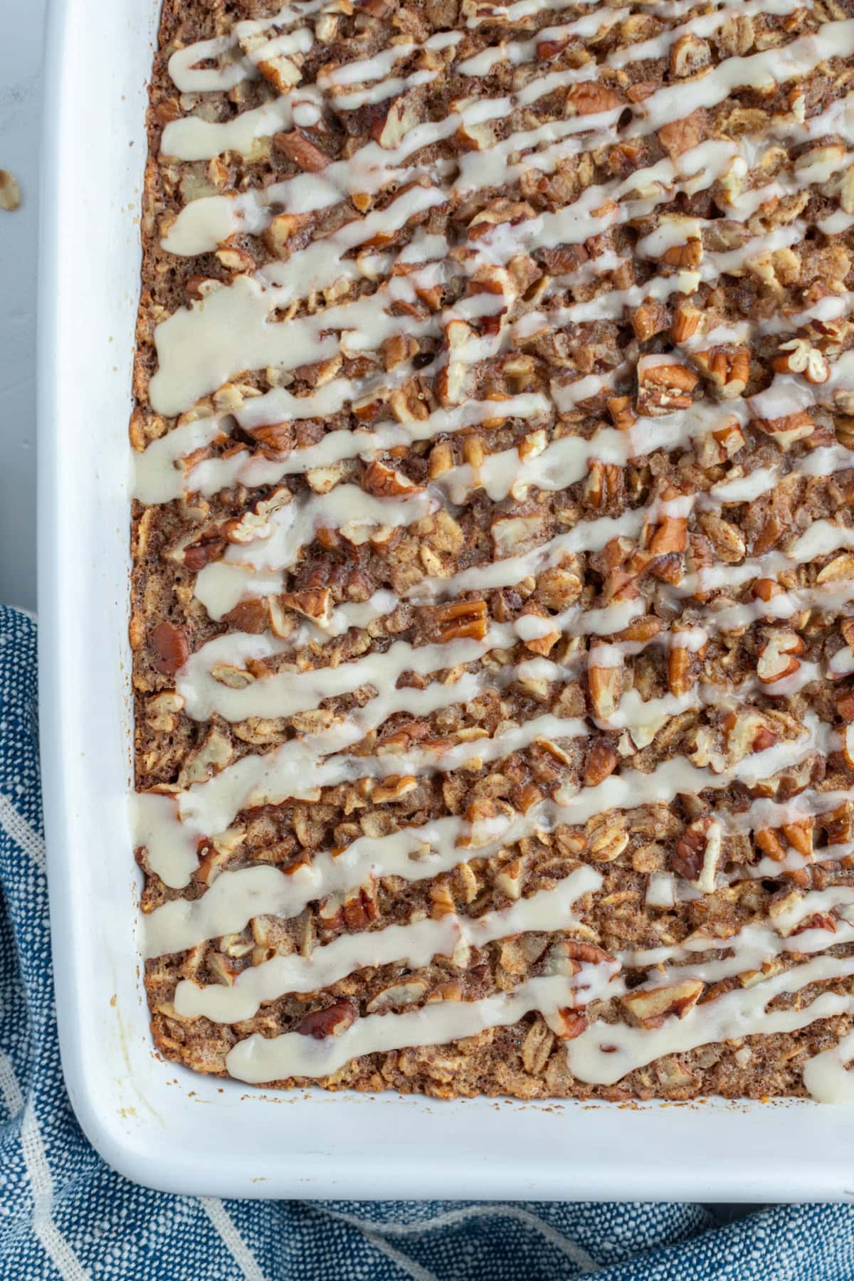 Cinnamon Roll Baked Oatmeal recipe from RecipeGirl.com close up cinnamon roll baked oatmeal in baking dish