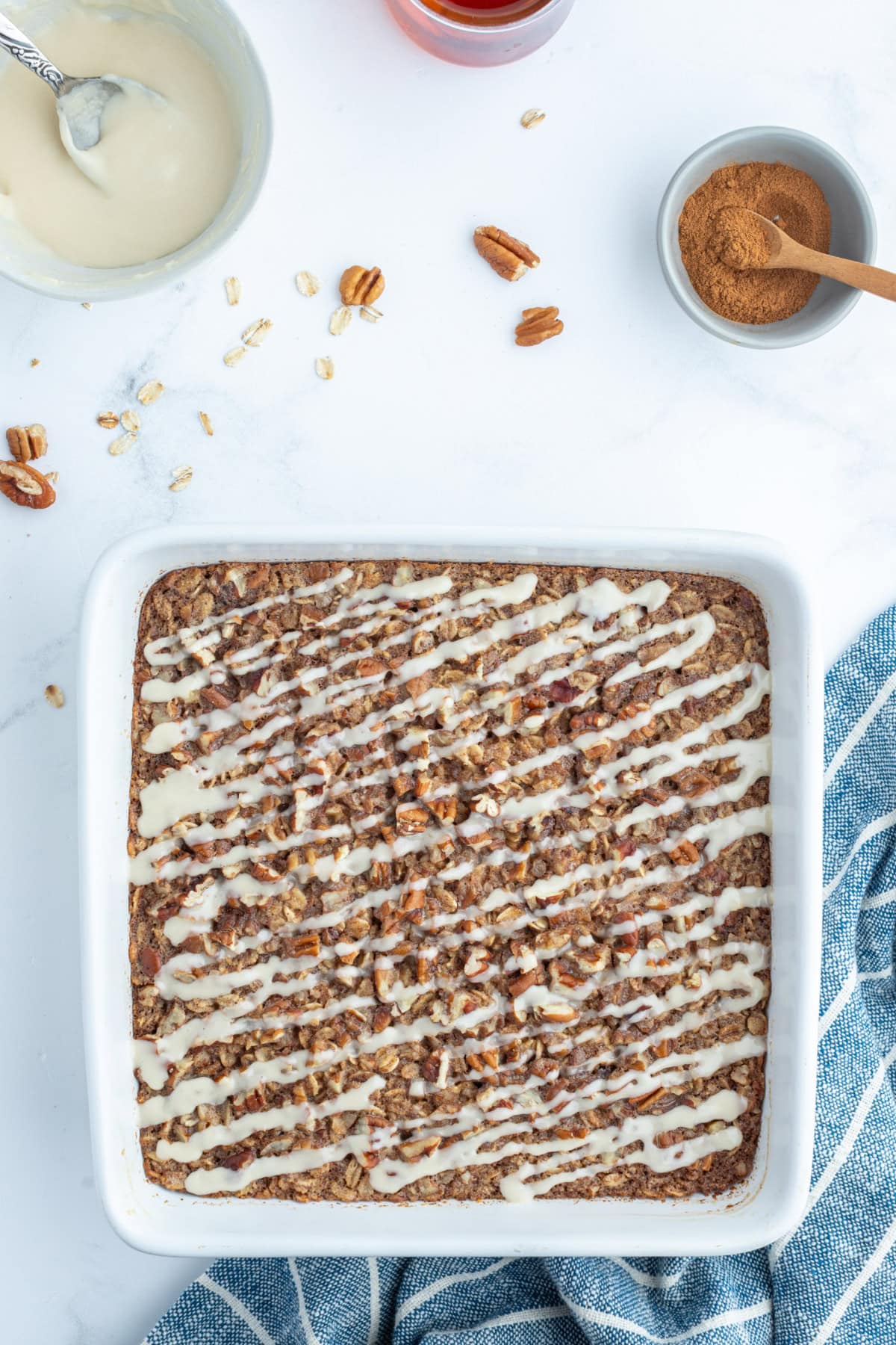 Cinnamon Roll Baked Oatmeal recipe from RecipeGirl.com cinnamon roll baked oatmeal in baking dish