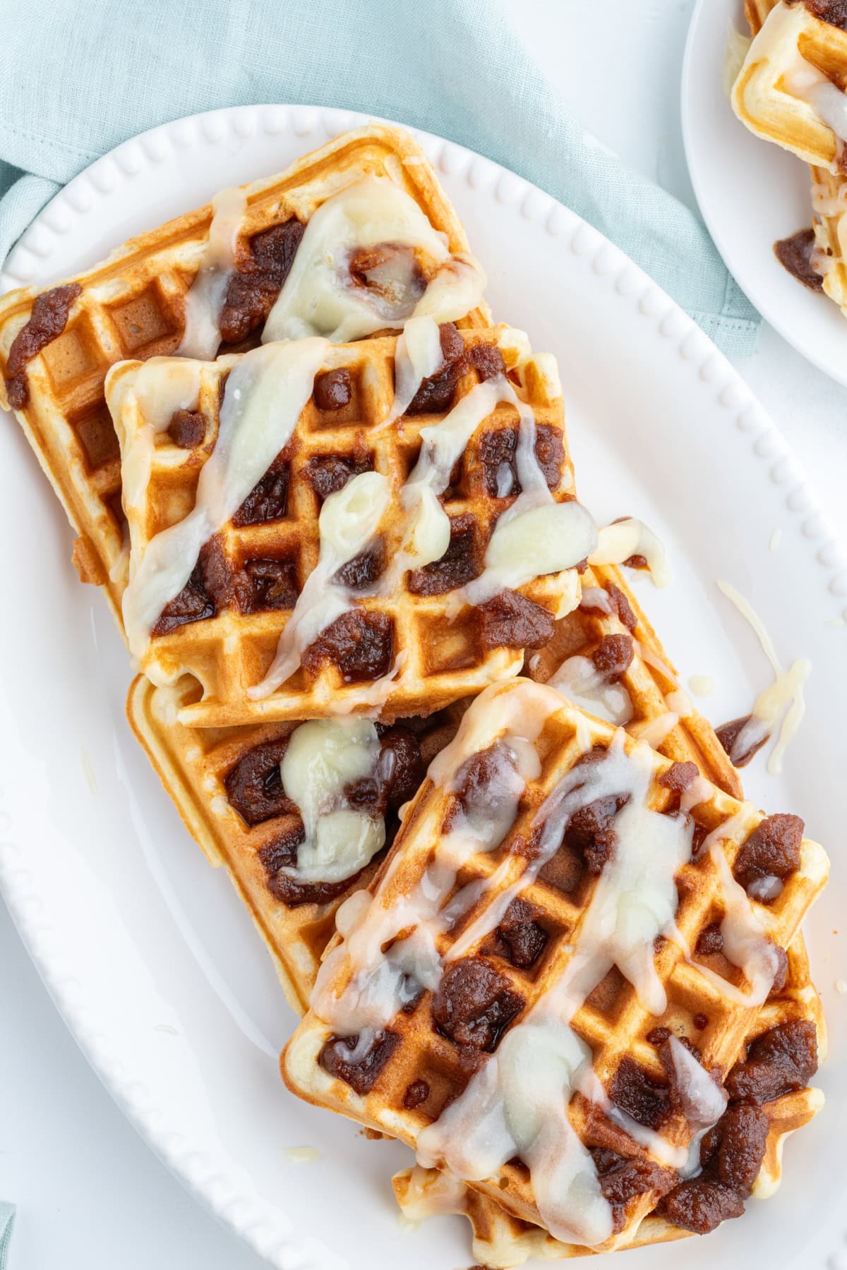 Cinnamon Roll Waffles recipe from RecipeGirl.com overhead shot of cinnamon roll waffles with toppings