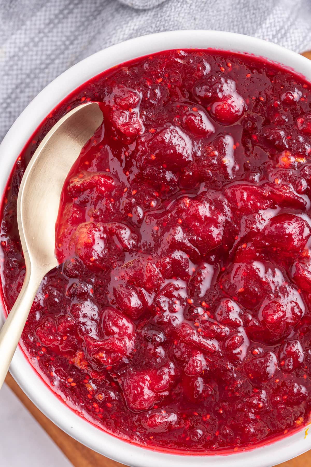 Classic Cranberry Sauce recipe from RecipeGirl.com classic cranberry sauce in a bowl with a spoon