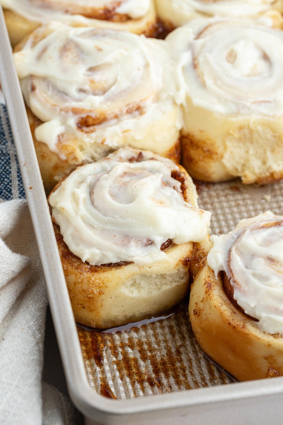 Copycat Cinnabon Cinnamon Rolls recipe from RecipeGirl.com cinnamon rolls in metal pan with icing