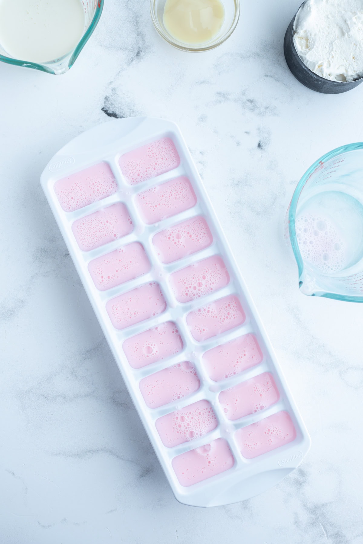 Copycat Wendy's Strawberry Frosty recipe from RecipeGirl.com ice cube tray of strawberry milk