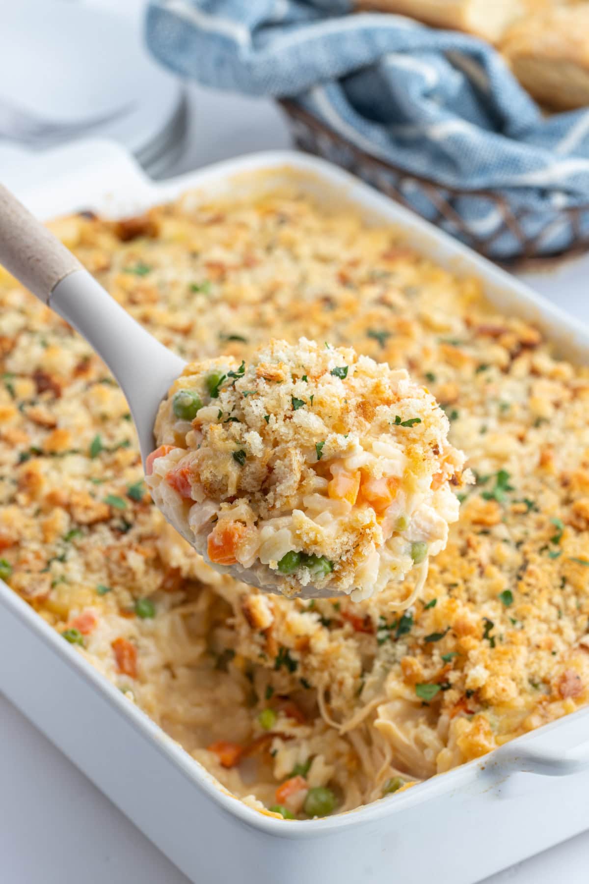 Creamy Chicken and Rice Casserole recipe from RecipeGirl.com : Easy family friendly casserole recipe spooning out creamy chicken and rice casserole out of dish