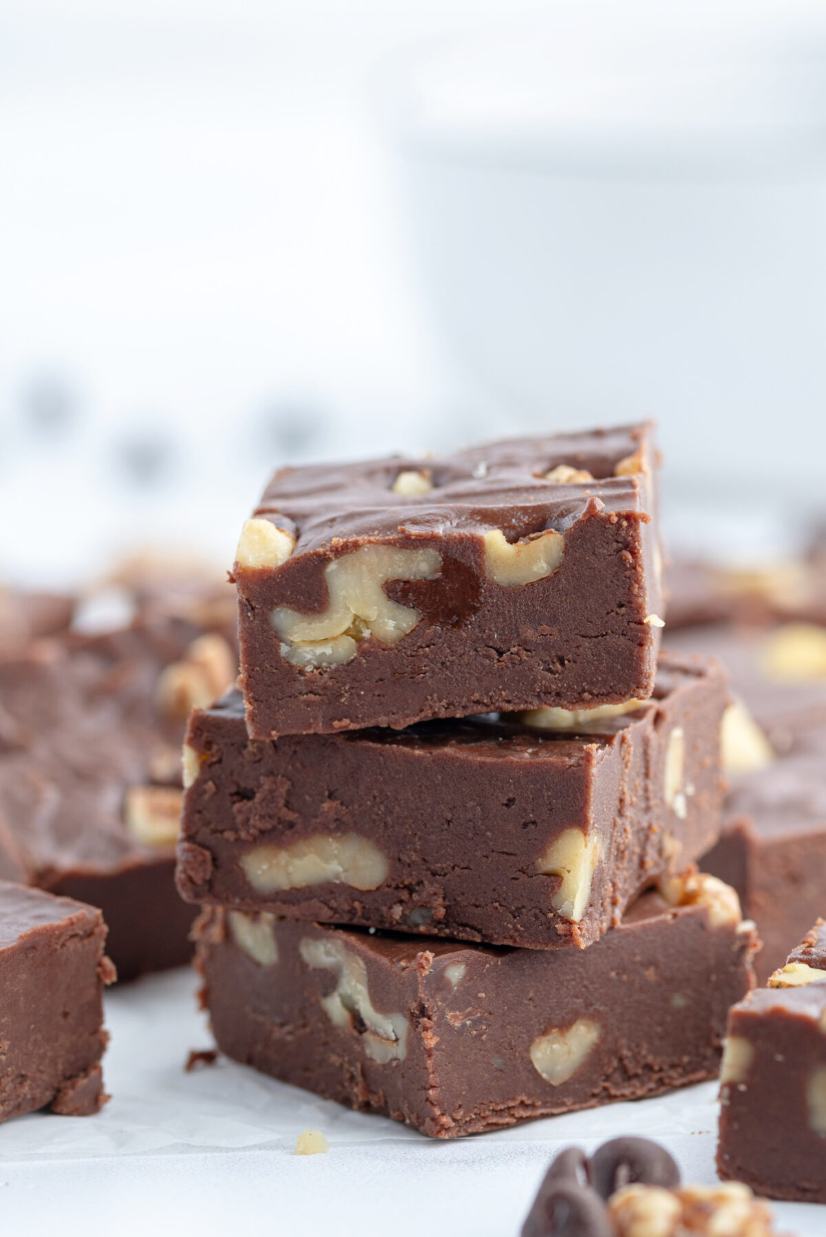 Creamy Chocolate Walnut Fudge recipe from RecipeGirl.com three pieces of fudge stacked