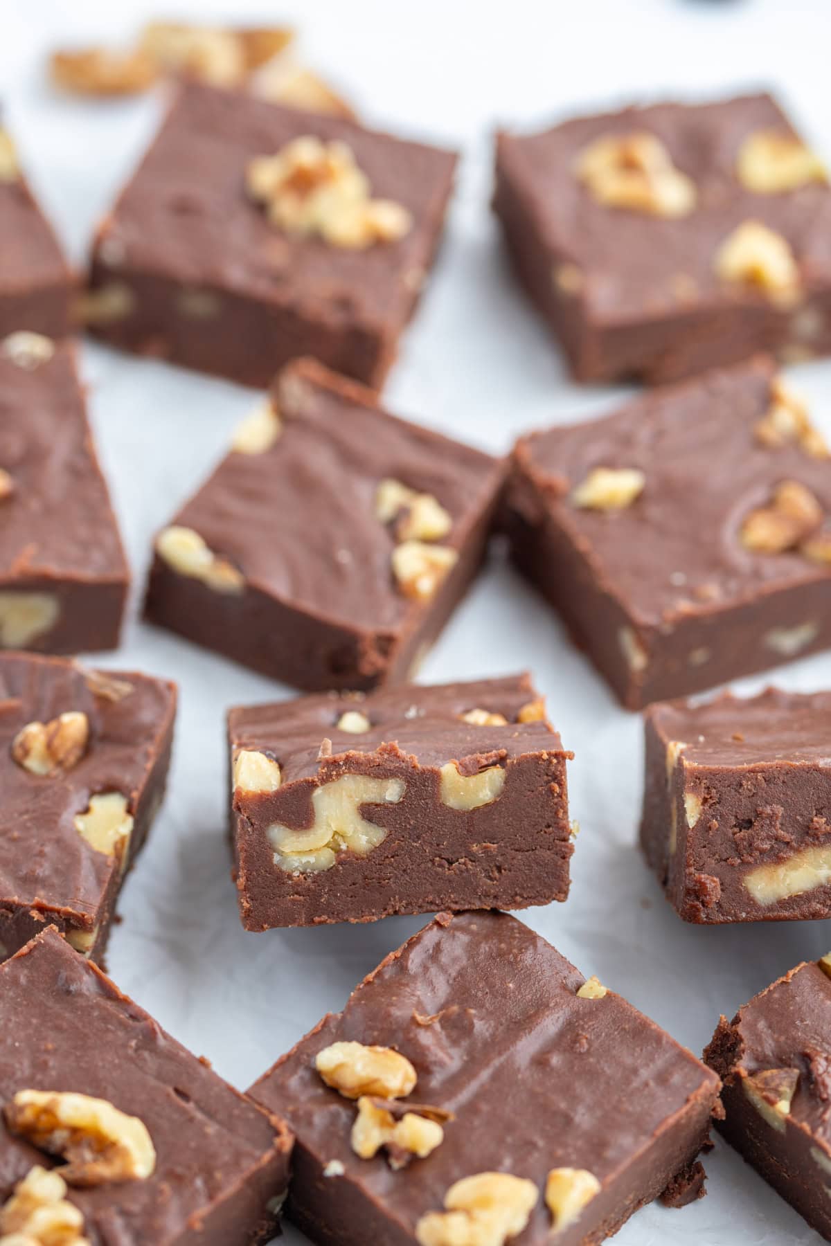 Creamy Chocolate Walnut Fudge recipe from RecipeGirl.com several pieces of creamy chocolate walnut fudge