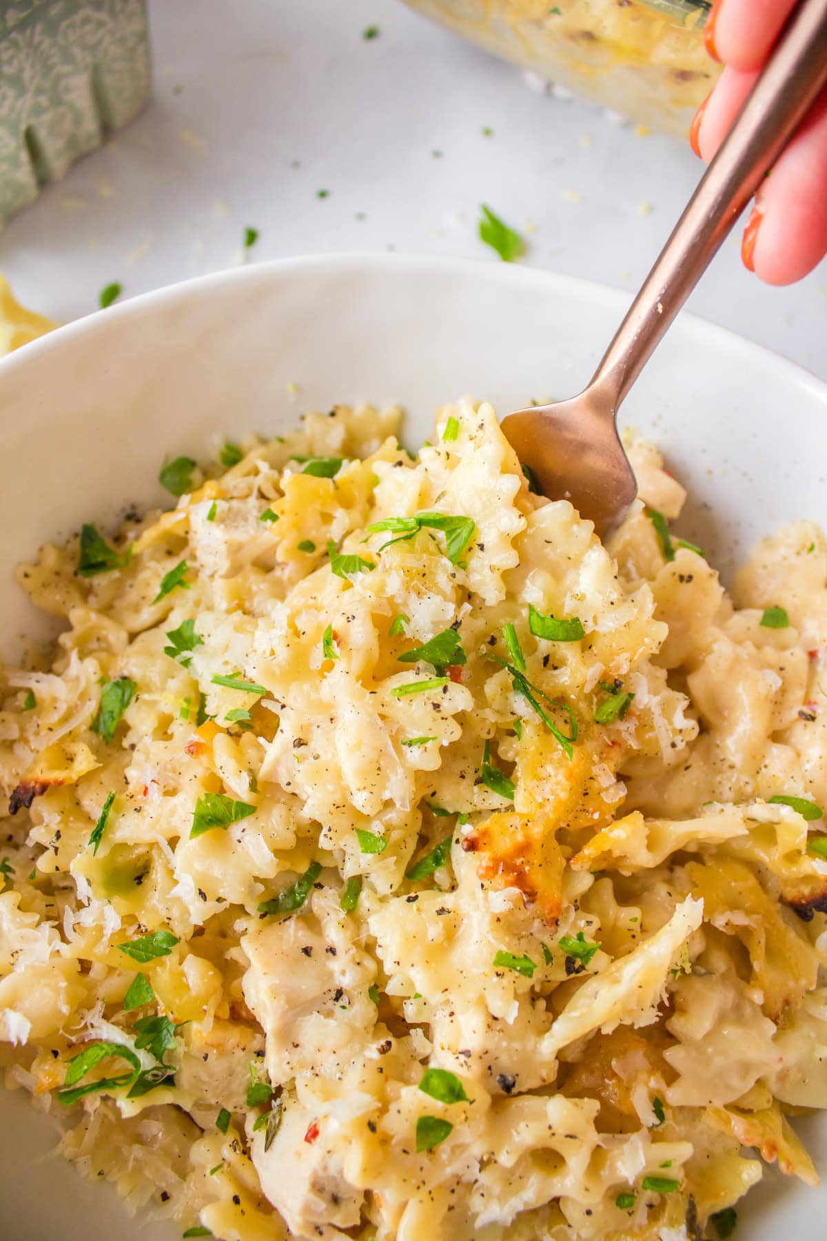 Creamy Lemon Chicken Pasta recipe from RecipeGirl.com bowl of creamy lemon chicken pasta with fork