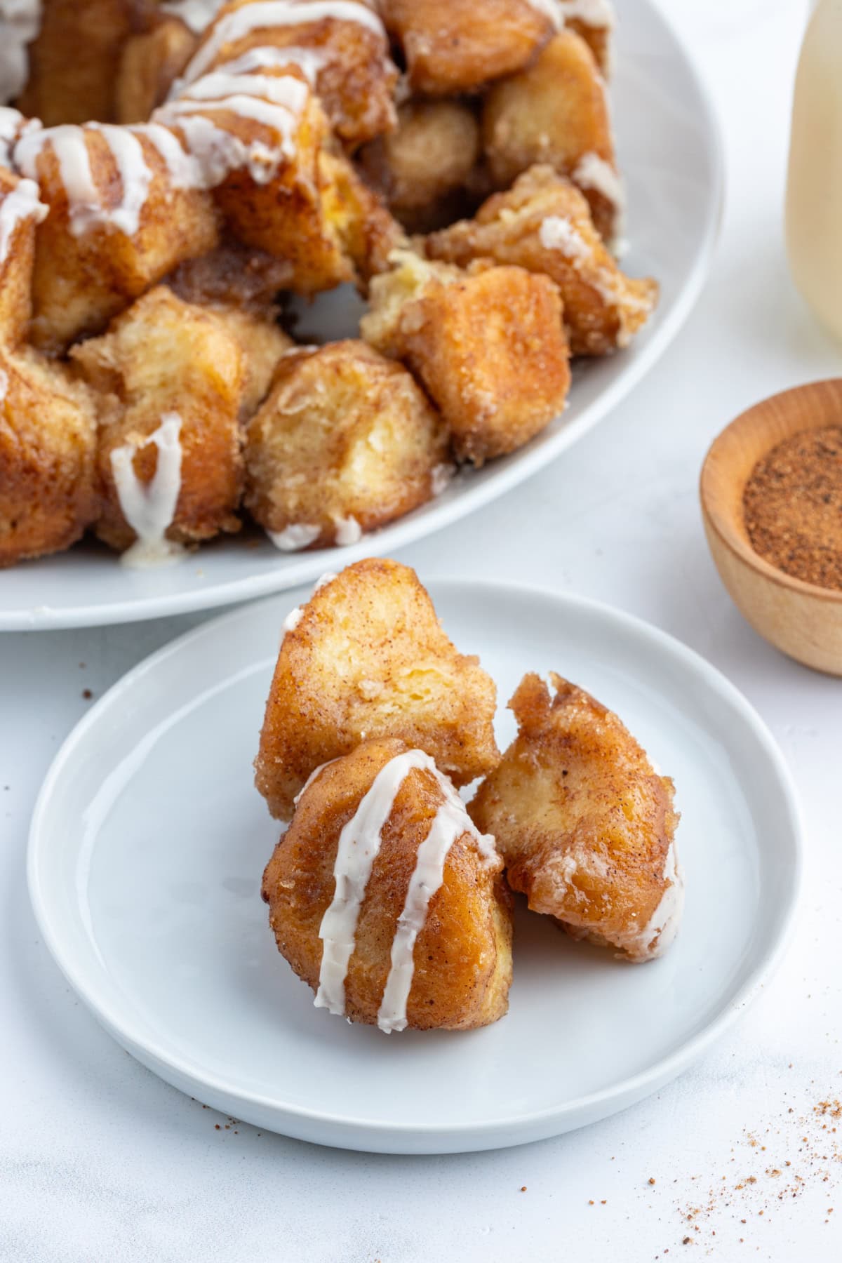 Eggnog Monkey Bread recipe from RecipeGirl.com pieces of eggnog monkey bread on plate