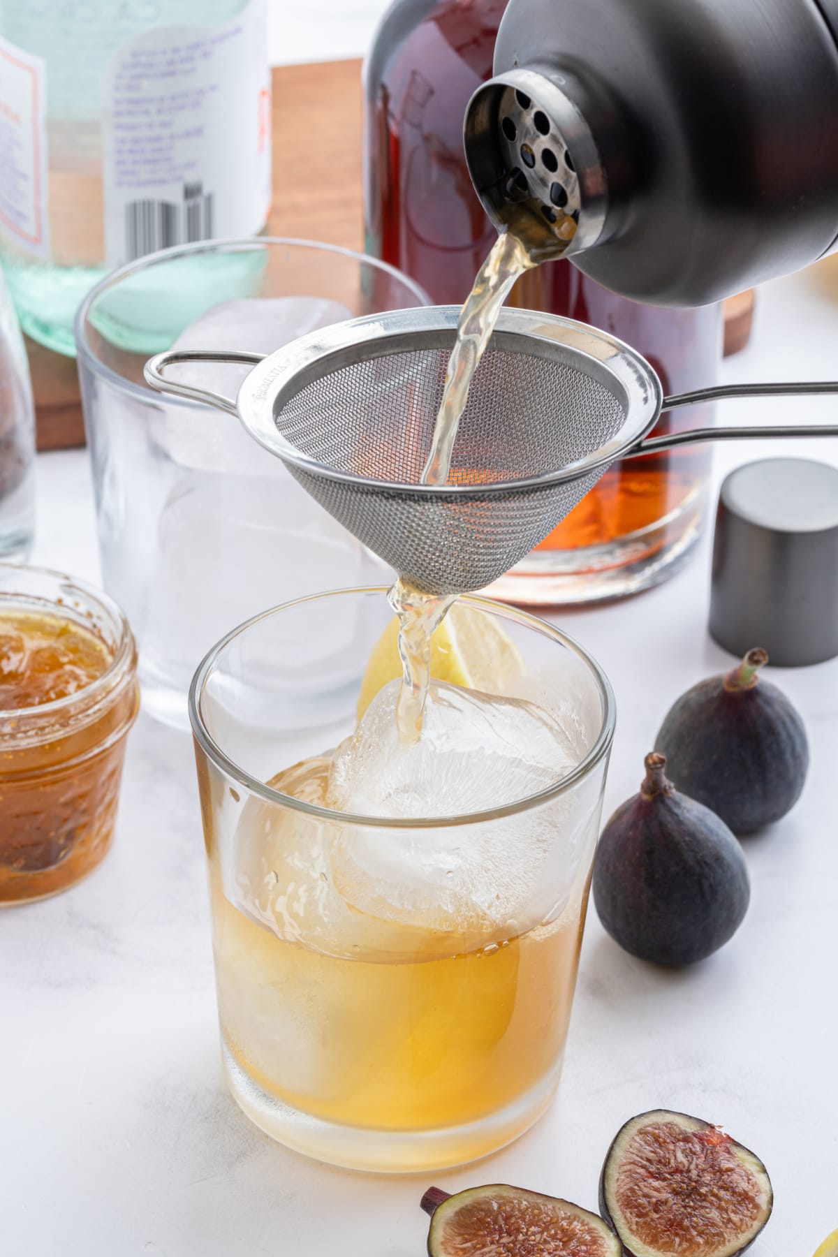 Fig Old Fashioned recipe from RecipeGirl.com pouring drink into glass