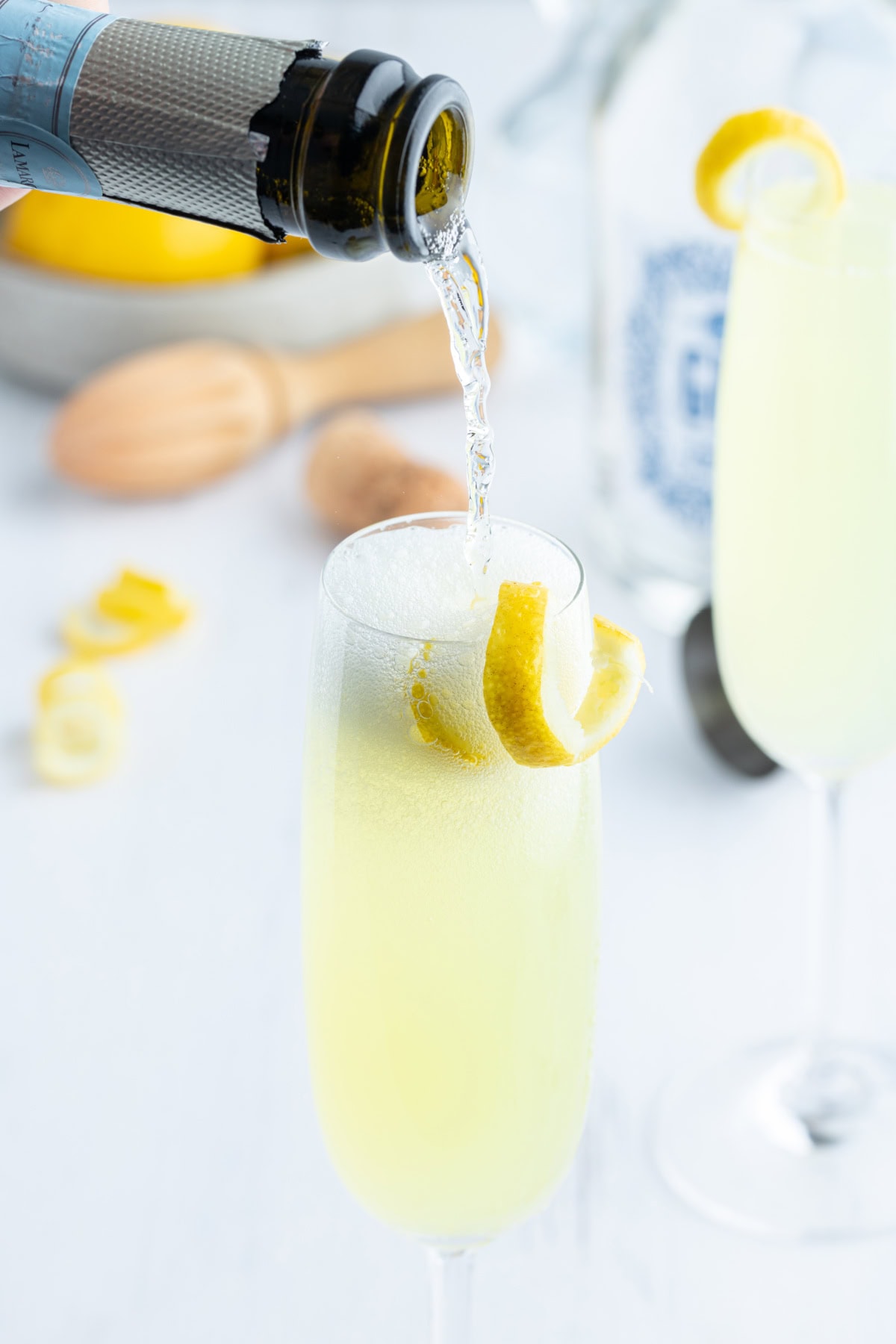 French 75 Cocktail recipe from RecipeGirl.com pouring sparkling wine into french 75 cocktail