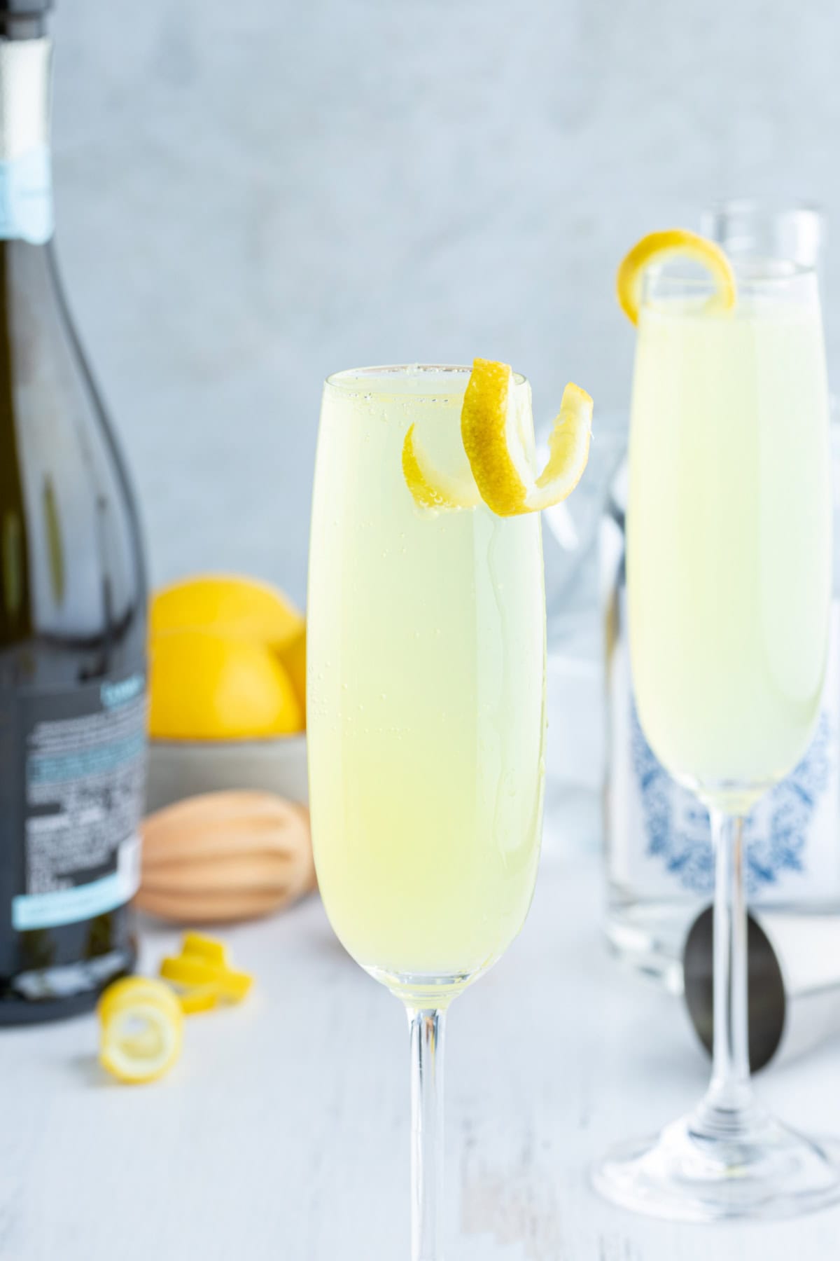 French 75 Cocktail recipe from RecipeGirl.com french 75 in glasses with lemon garnish