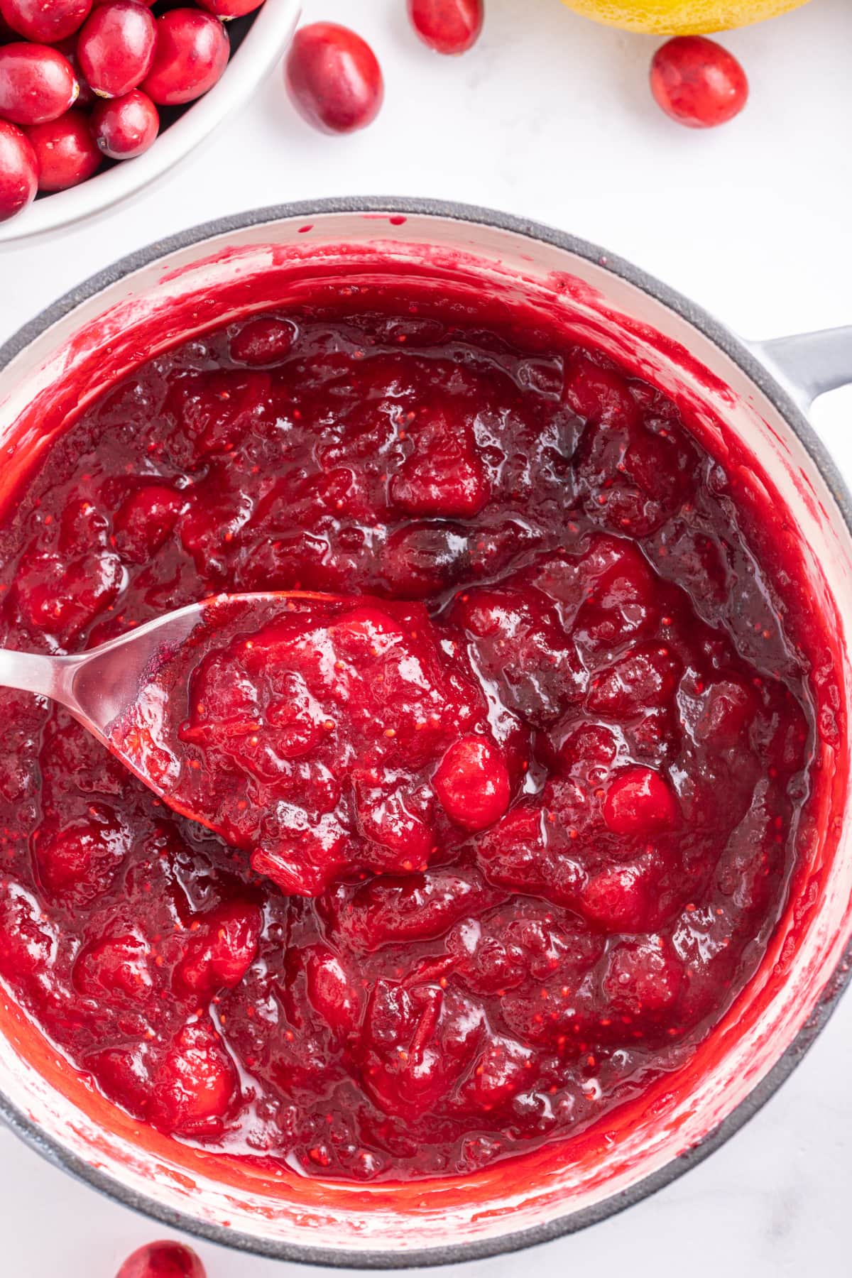 Fresh Cranberry Jam recipe from RecipeGirl.com pot of fresh cranberry jam with a spoon