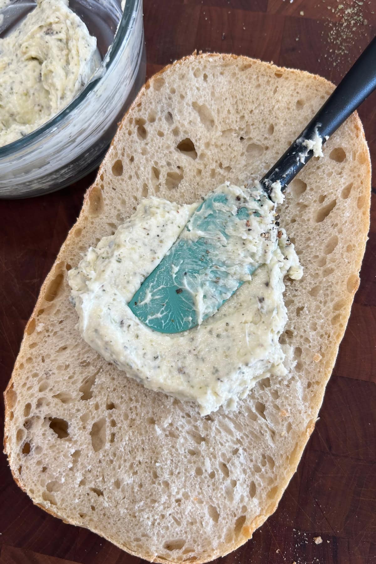 Garlic Bread Spread recipe from RecipeGirl.com spreading garlic bread spread onto bread
