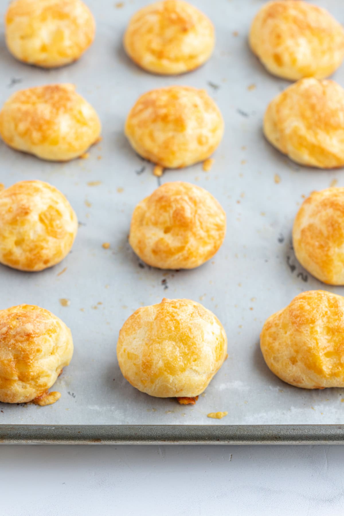 Gougeres French cheese puffs recipe from RecipeGirl.com gougeres on baking sheet