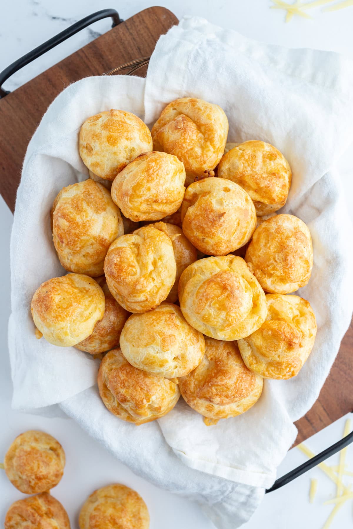 Gougeres French cheese puffs recipe from RecipeGirl.com overhead shot of cloth lined basket of gougeres