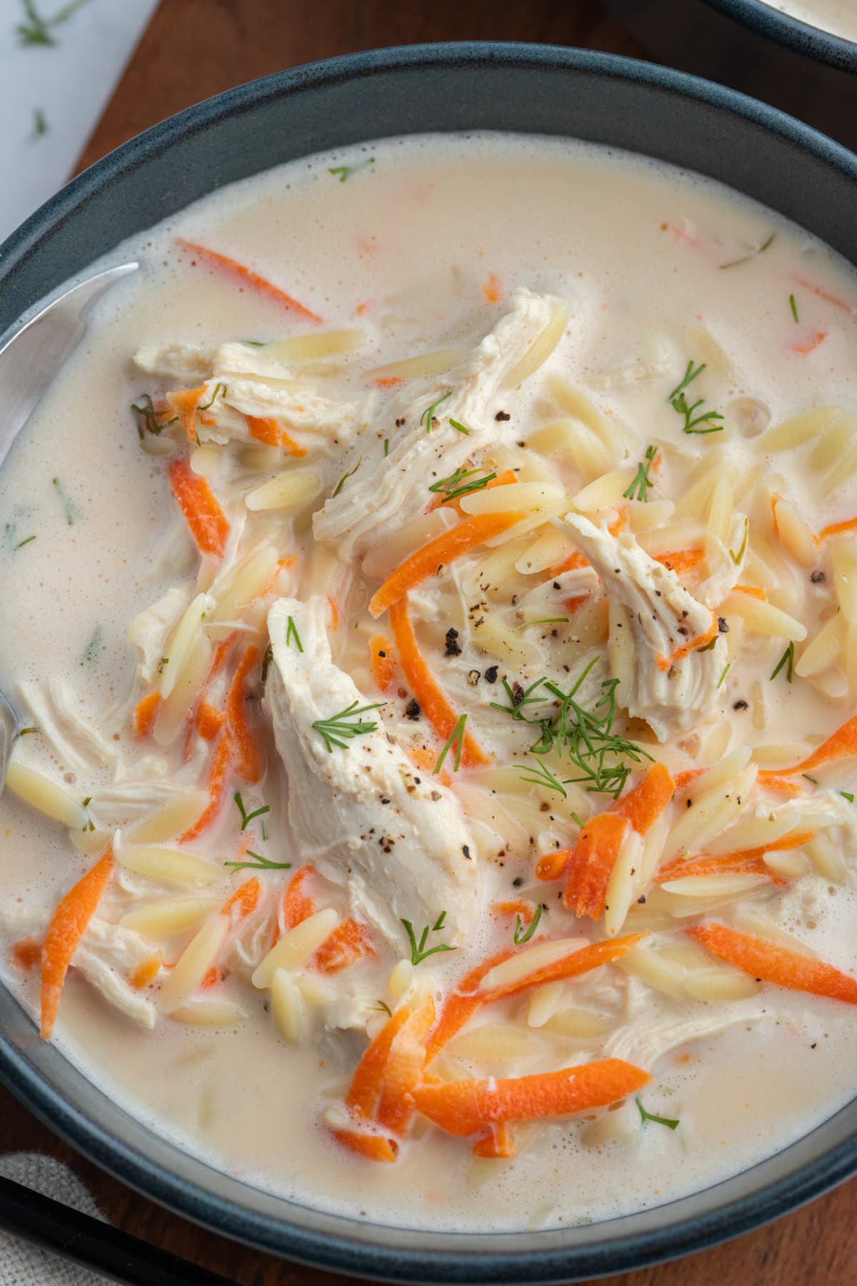 Greek Orzo and Chicken Soup recipe from RecipeGirl.com close up of greek orzo and chicken soup in bowl