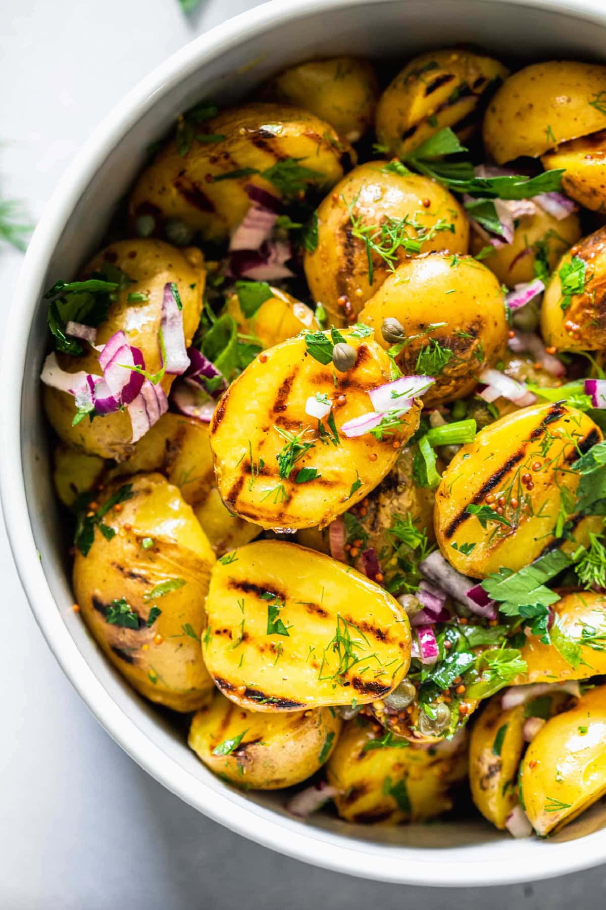 21 Favorite Potato Salad Recipes collection on RecipeGirl.com Grilled Potato Salad with Tangy Mustard Dressing in bowl