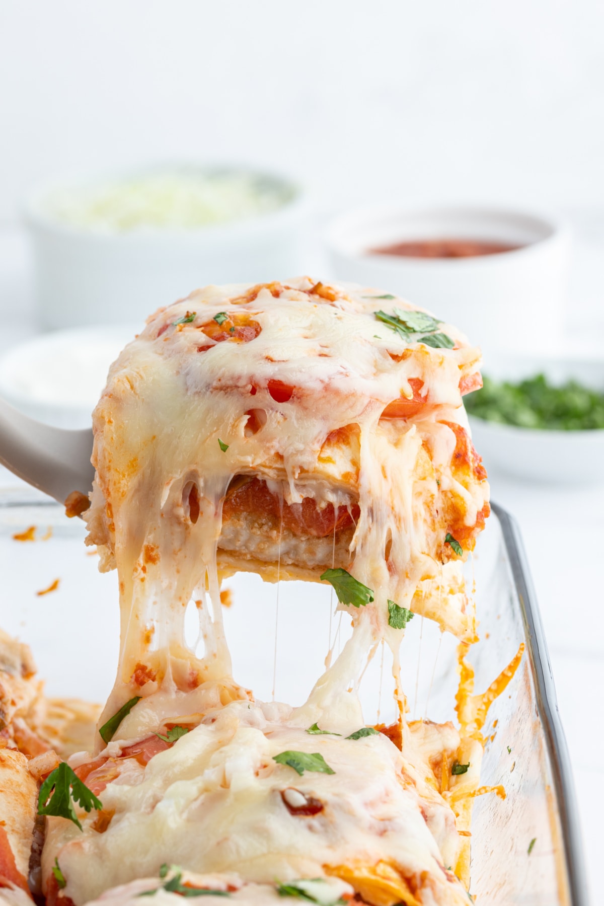 Inside Out Fish Tacos, otherwise known as Fish Taco Casserole recipe from RecipeGirl.com spatula scooping out serving of fish taco casserole
