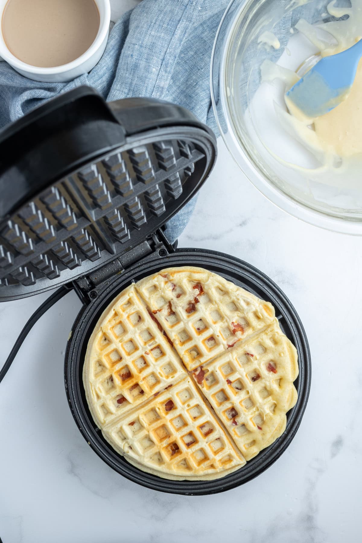Maple Bacon Waffles recipe from RecipeGirl.com maple bacon waffle in a waffle iron