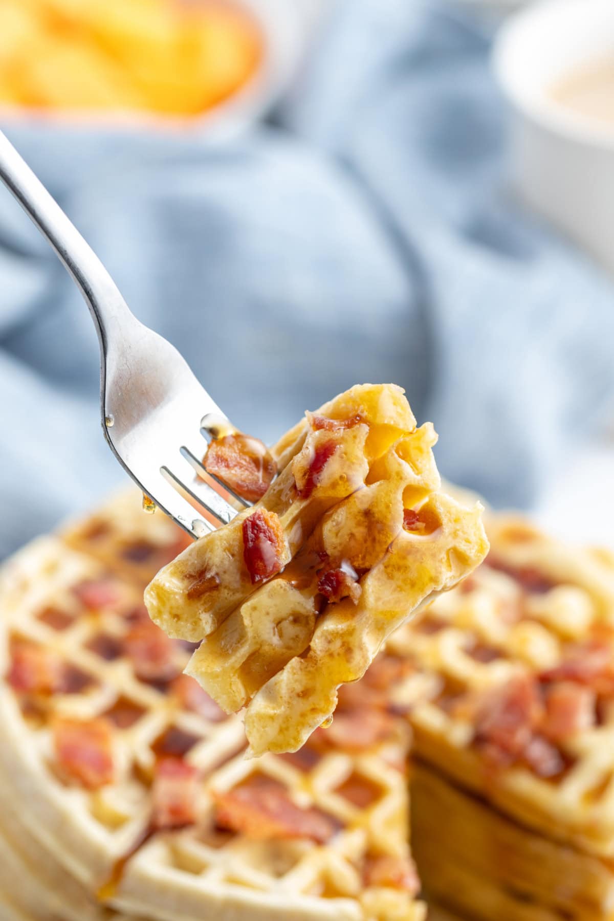 Maple Bacon Waffles recipe from RecipeGirl.com fork full of maple bacon waffle