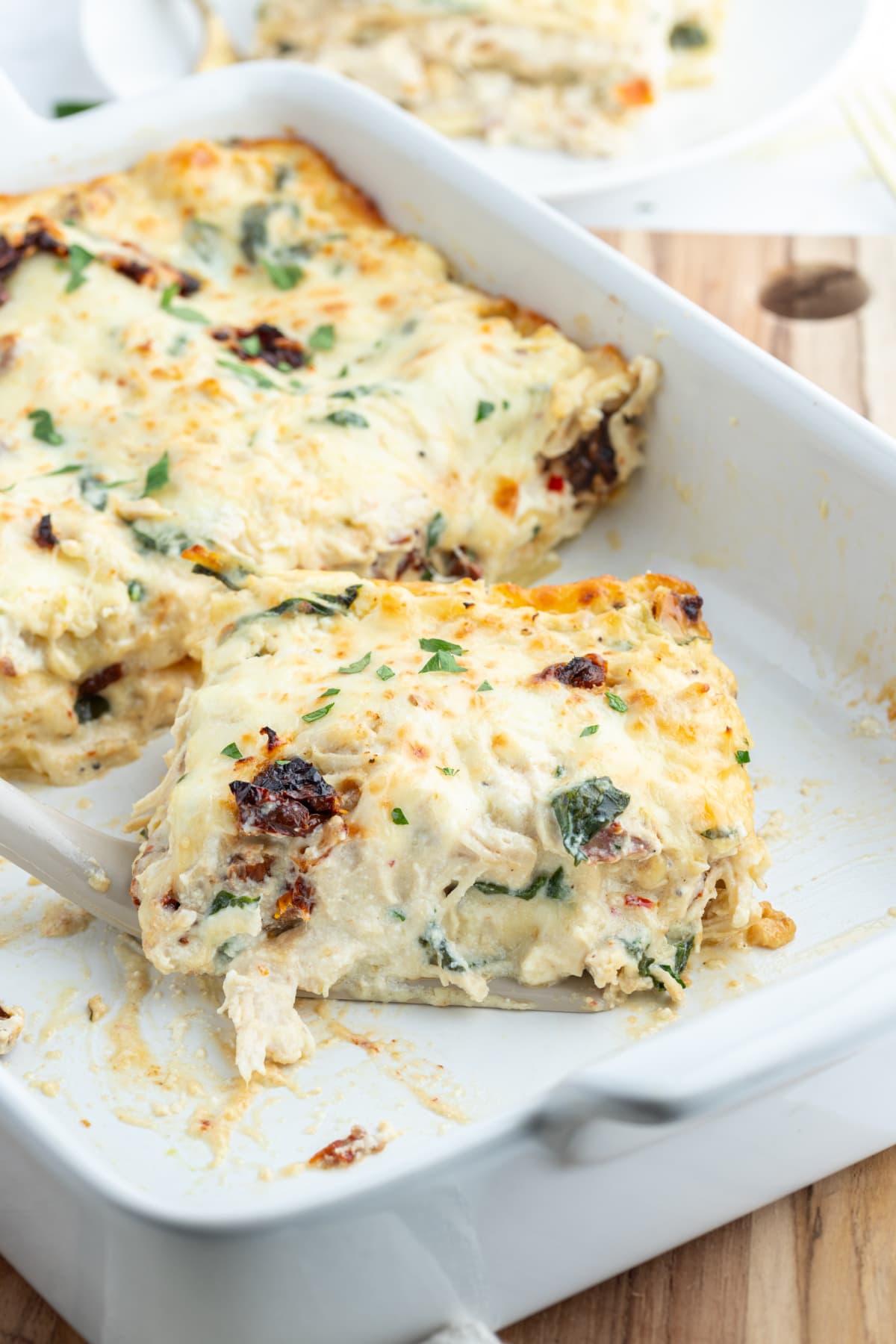Marry Me Chicken Lasagna recipe from RecipeGirl.com dish of marry me chicken lasagna sliced up