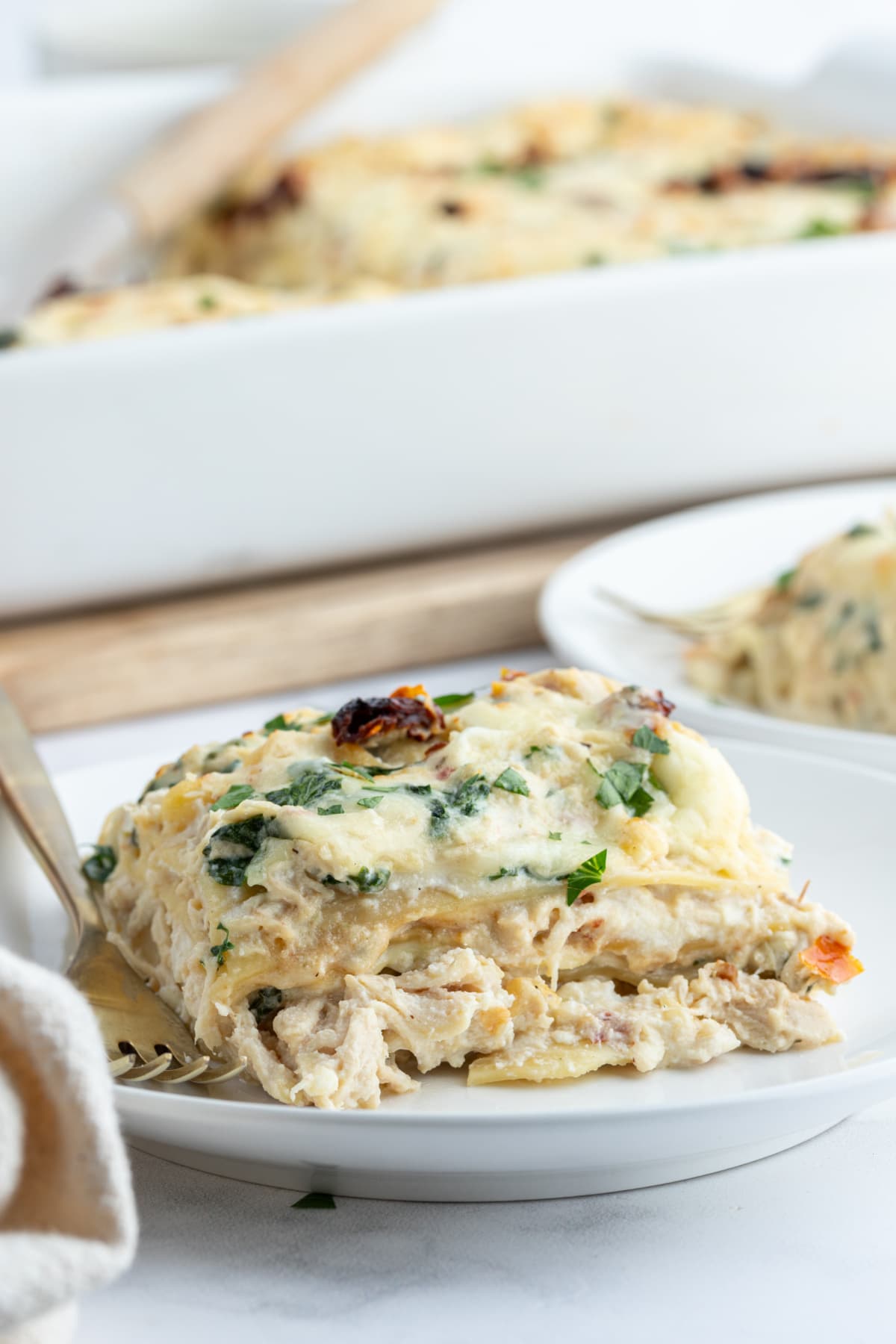 Marry Me Chicken Lasagna recipe from RecipeGirl.com serving of marry me chicken lasagna on plate