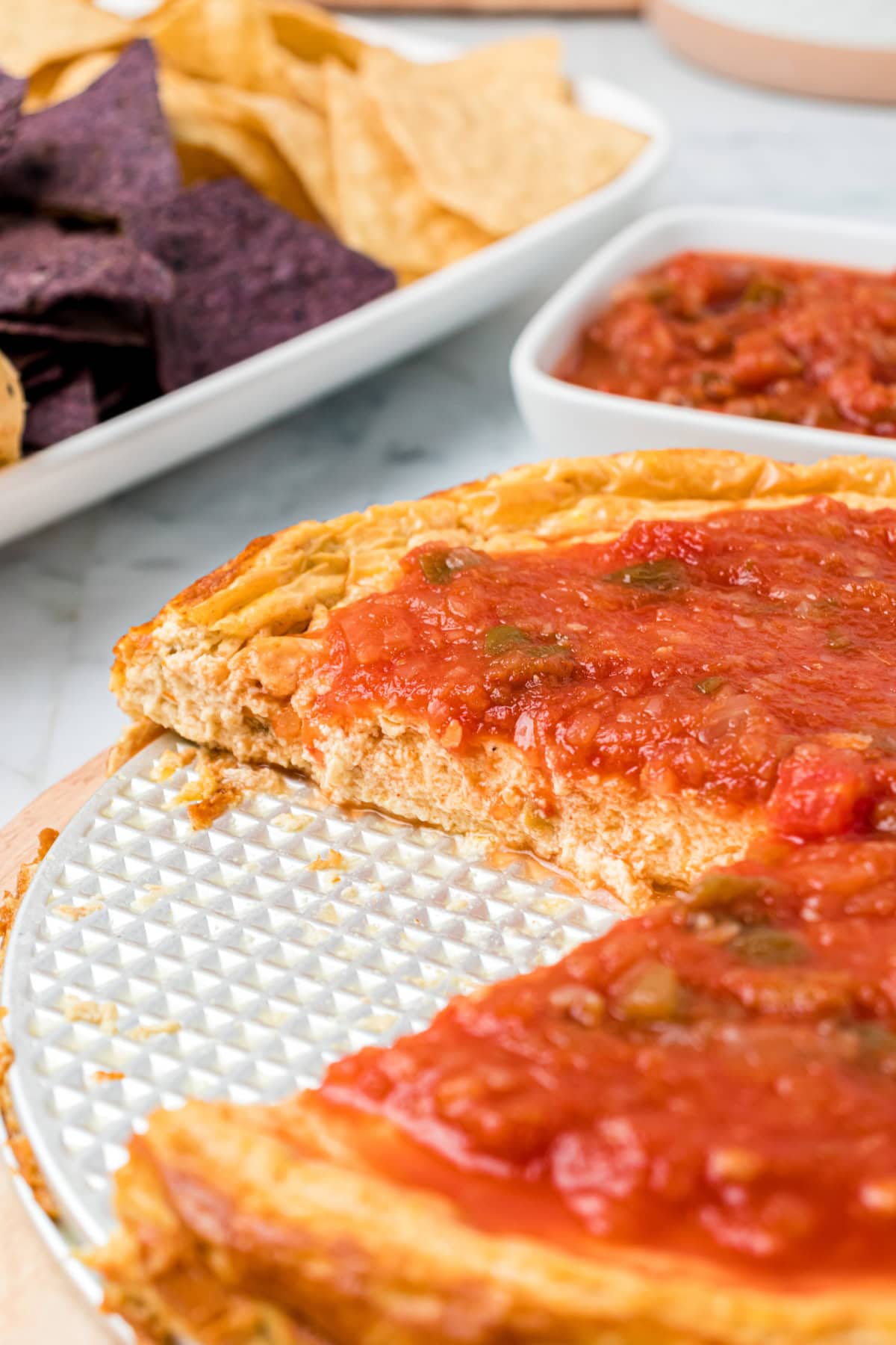 Mexican Cheesecake Dip recipe from RecipeGirl.com mexican cheesecake dip with big slice taken out