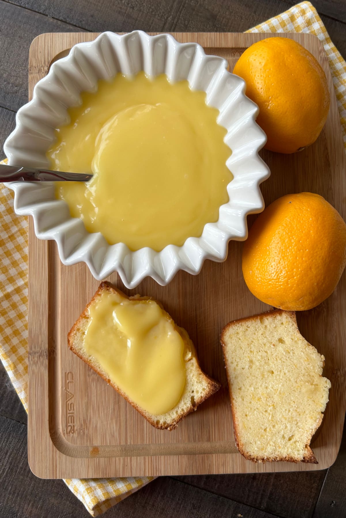 Easy Meyer Lemon Curd recipe from RecipeGirl.com meyer lemon curd in bowl and slices of bread with lemon curd spread on