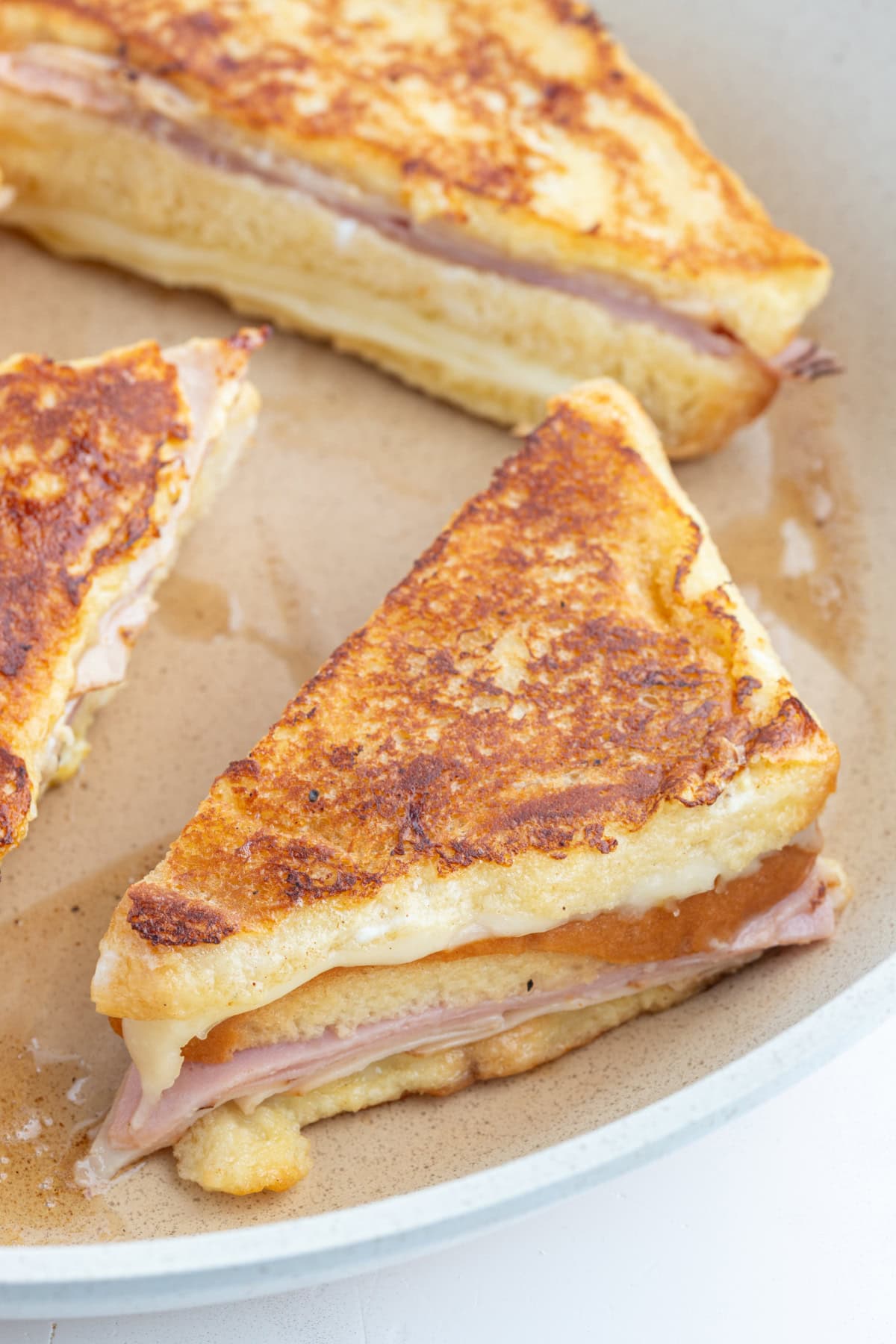Monte Cristo Sandwich : classic French recipe from RecipeGirl.com monte cristo sandwich halves on board after frying