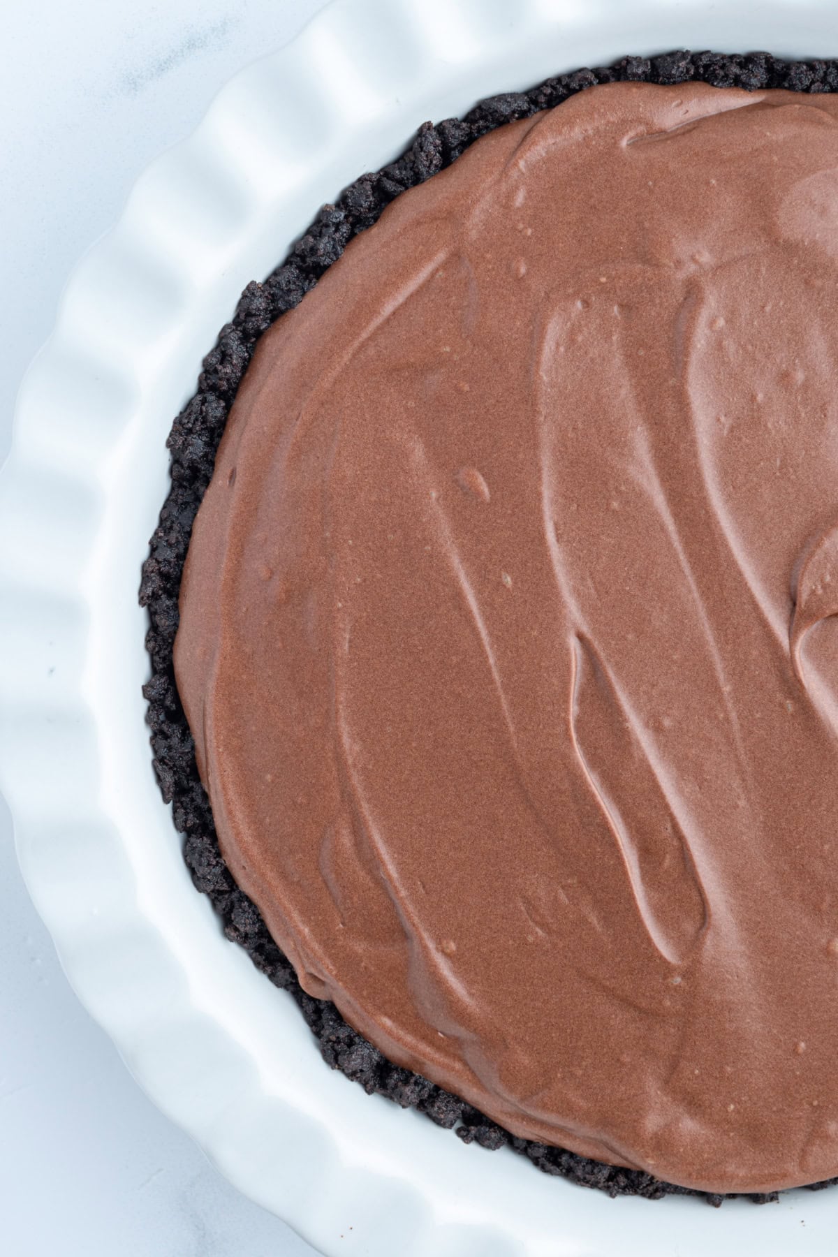 No Bake Easy Chocolate Truffle Pie recipe from RecipeGirl.com overhead shot of half of a chocolate truffle pie