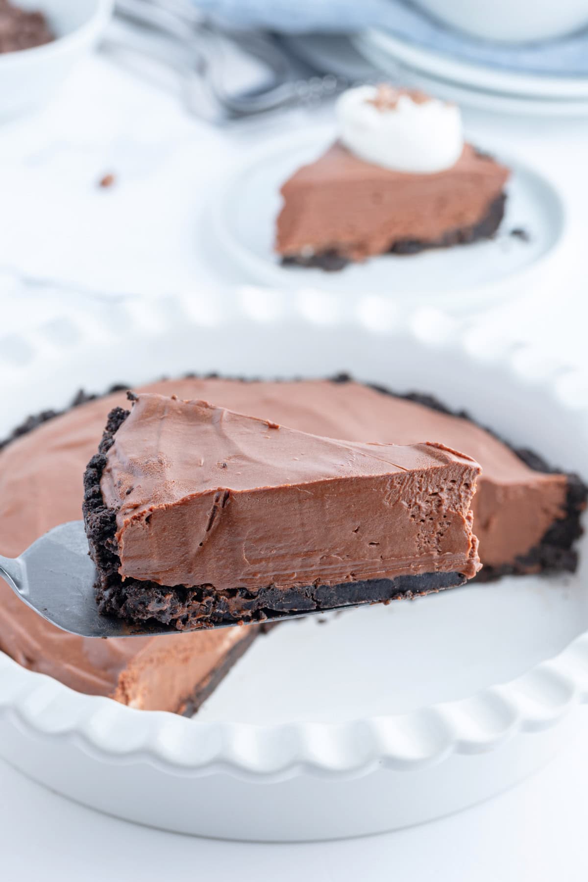 No Bake Easy Chocolate Truffle Pie recipe from RecipeGirl.com spatula holding slice of no bake easy chocolate truffle pie