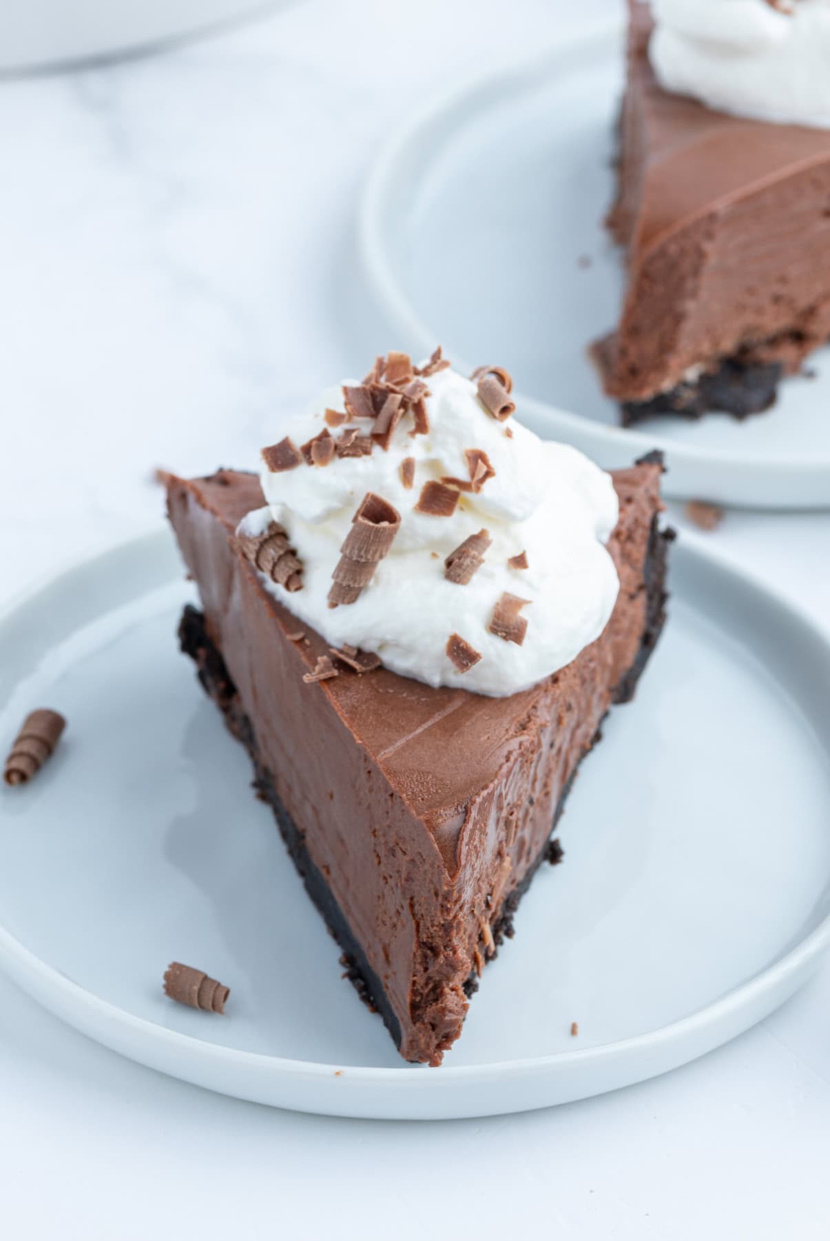 No Bake Easy Chocolate Truffle Pie recipe from RecipeGirl.com slice of easy chocolate truffle pie with whipped cream on top