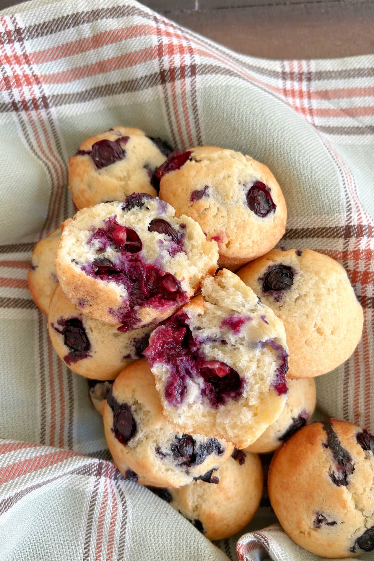 Old Fashioned Blueberry Muffins recipe from RecipeGirl.com blueberry muffins in basket with one broken open
