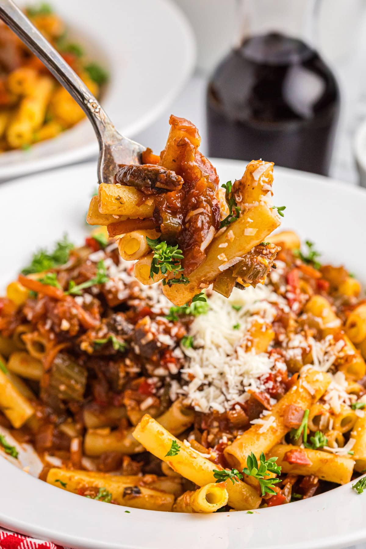 Pasta with Garden Bolognese recipe from RecipeGirl.com fork into bowl of pasta with garden bolognese