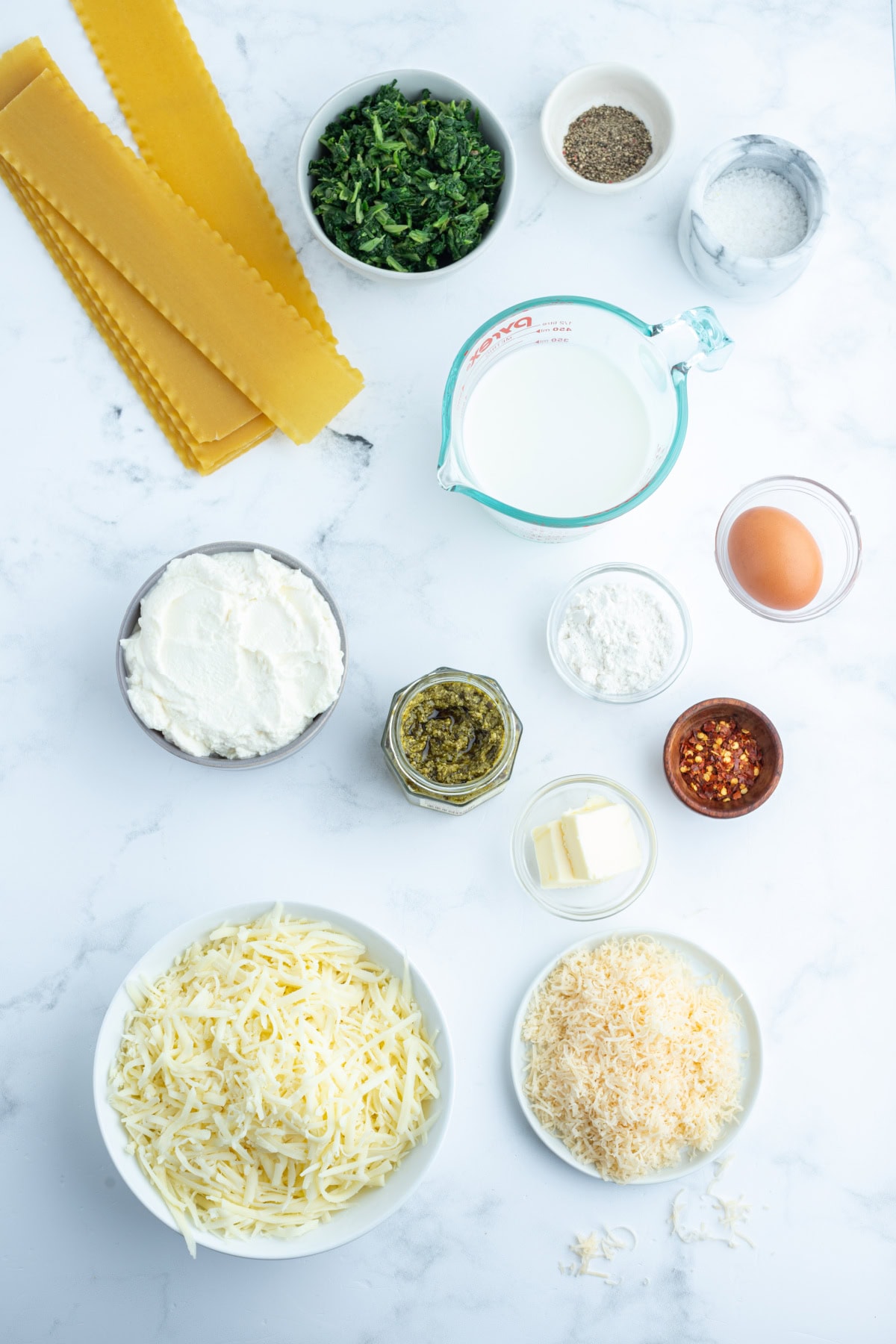 Pesto Lasagna Rolls recipe from RecipeGirl.com ingredients displayed for making pesto lasagna rolls