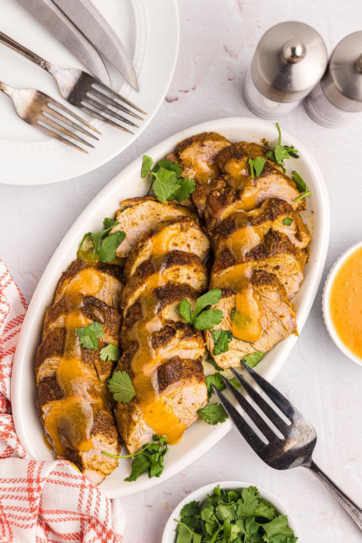 Pork Tenderloin with Apricot Ginger Sauce recipe from RecipeGirl.com platter of pork tenderloin with apricot ginger sauce