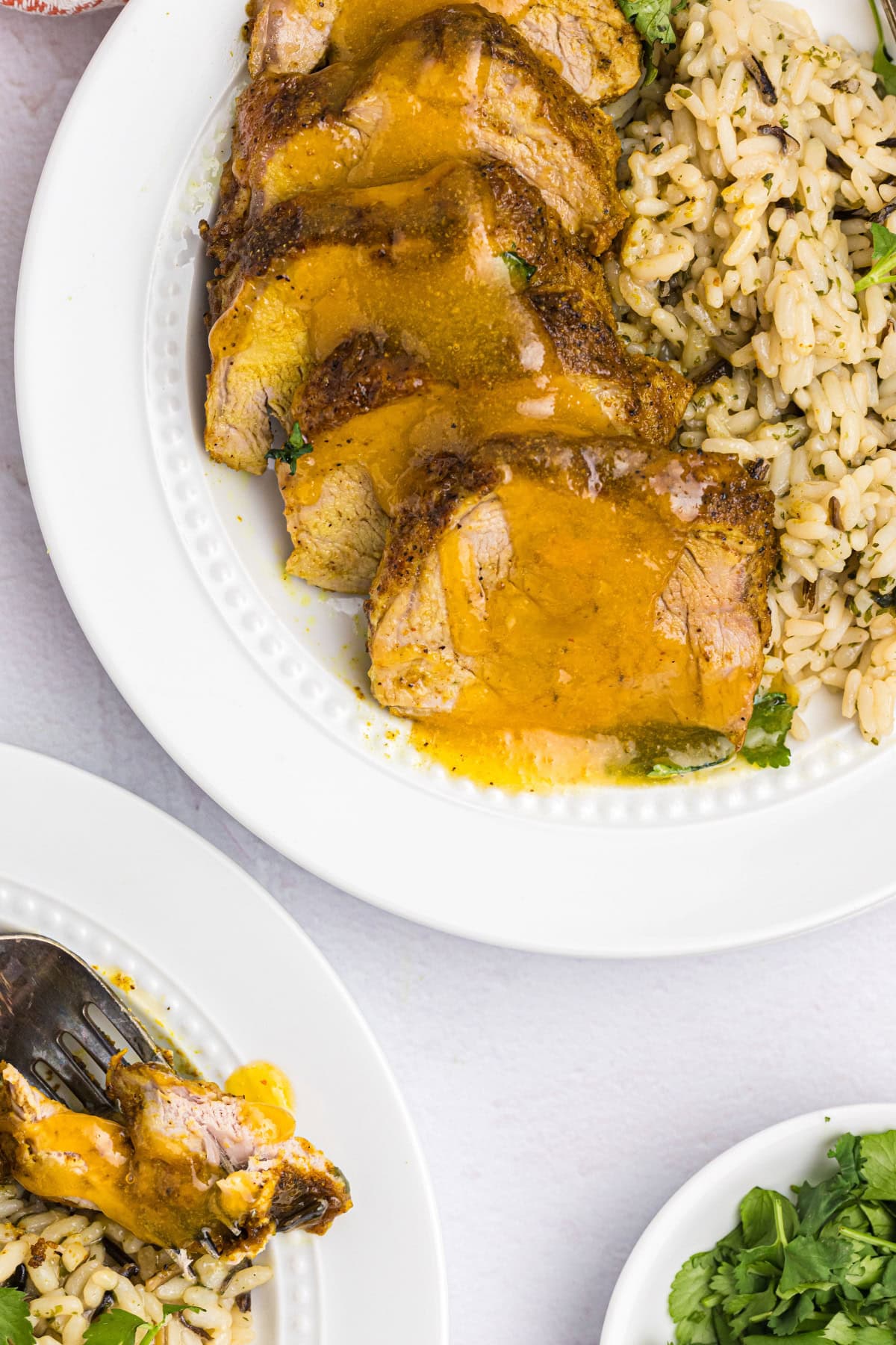 Pork Tenderloin with Apricot Ginger Sauce recipe from RecipeGirl.com sliced pork tenderloin on plate topped with apricot ginger sauce